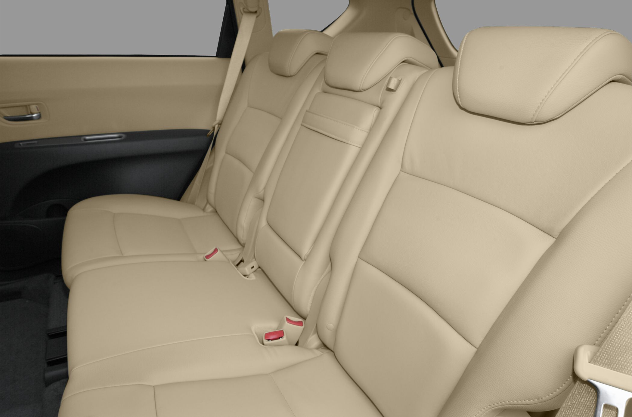 Beige leather rear seats with headrests and seat belts.