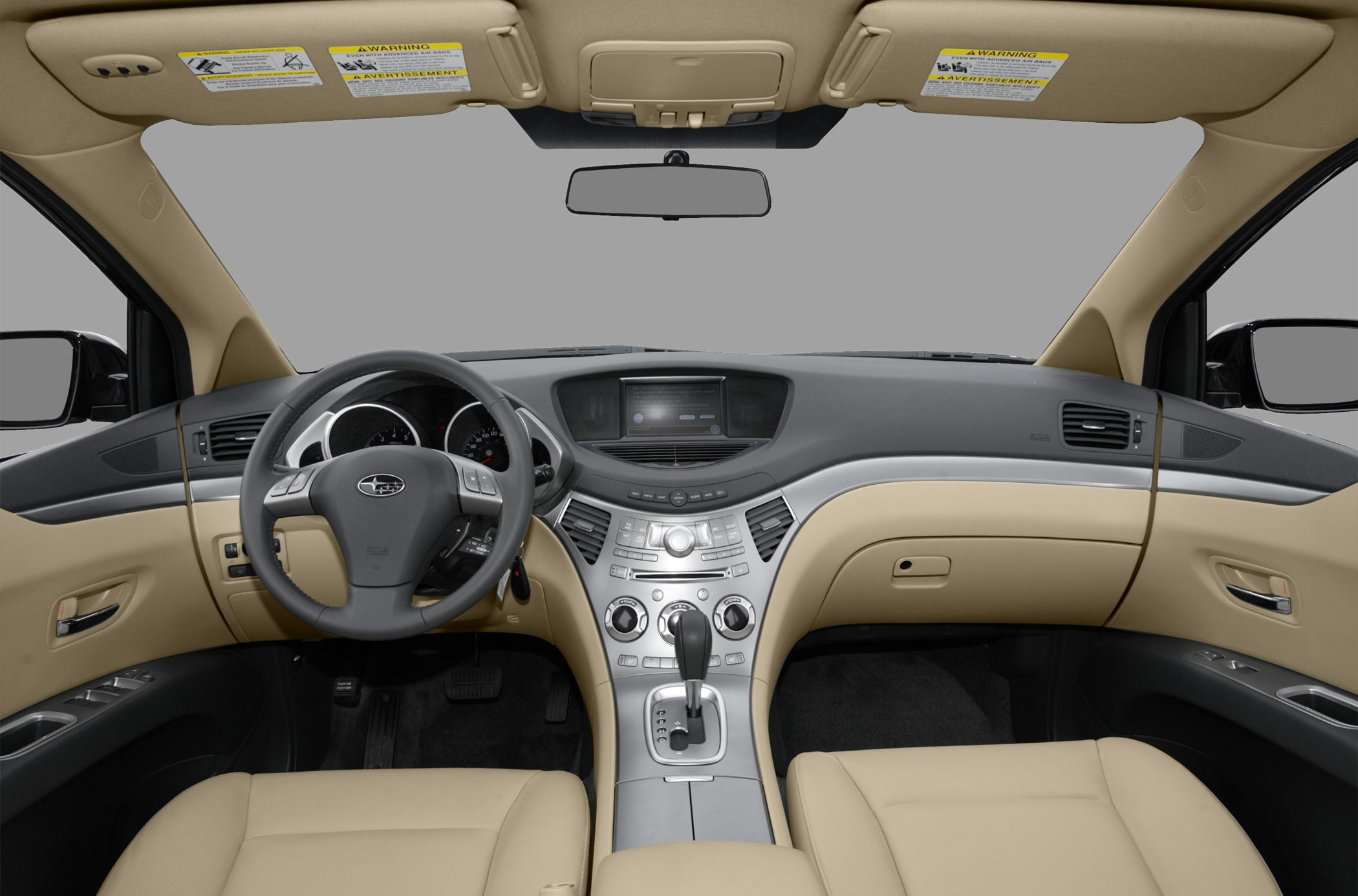 Beige car interior with dashboard, multifunction steering wheel, and central console.
