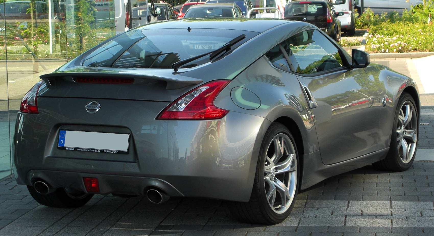 Rear view with spoiler, dual exhaust, and aerodynamic taillights