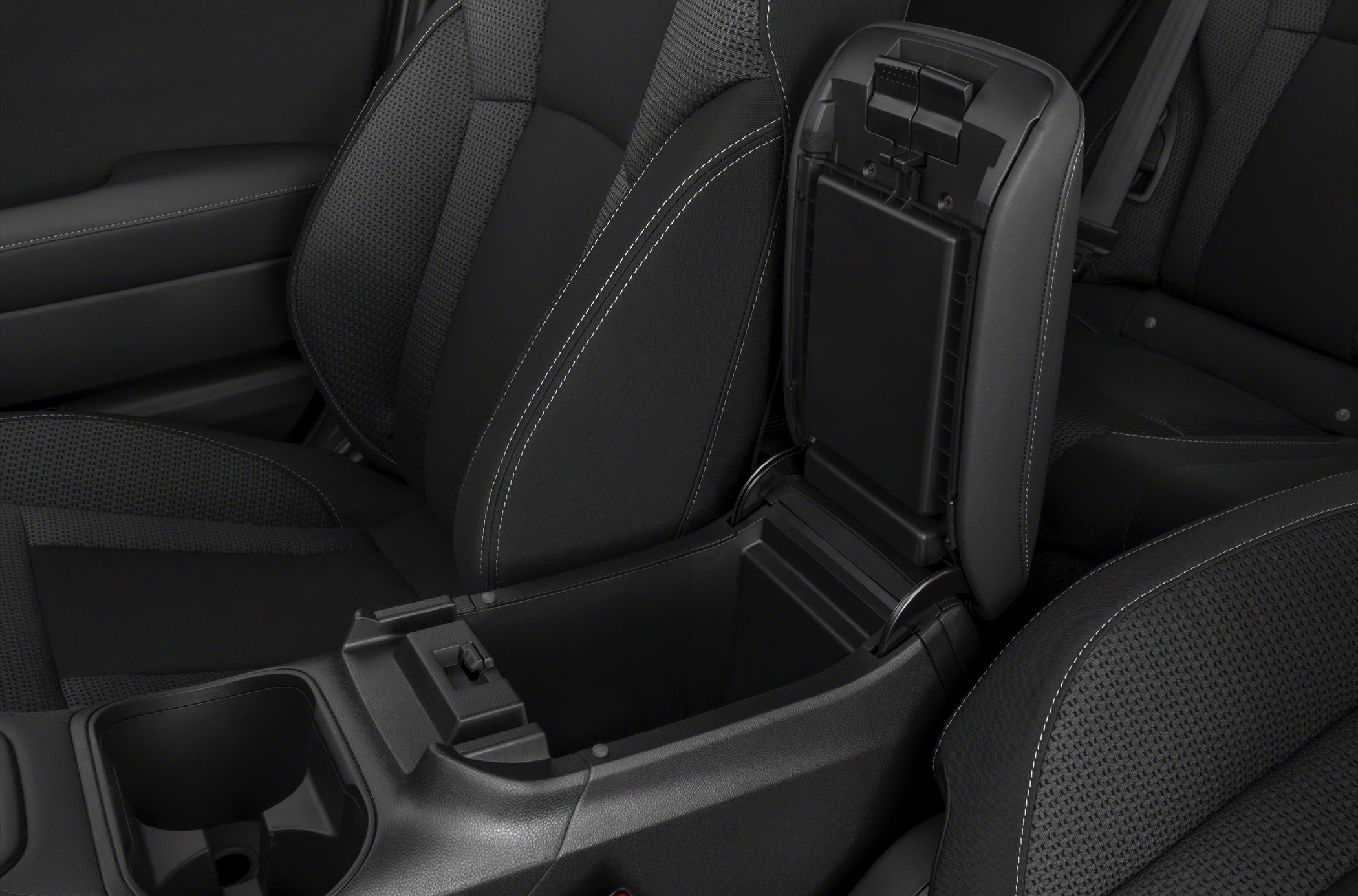 Open center console storage and front seats upholstery in a car interior