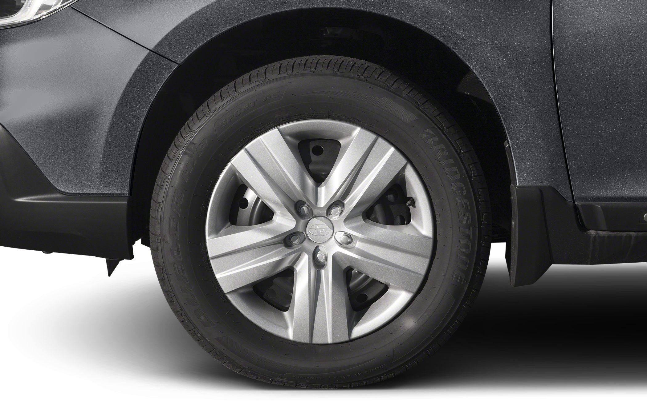 Close-up of alloy wheel with Bridgestone tire on dark vehicle