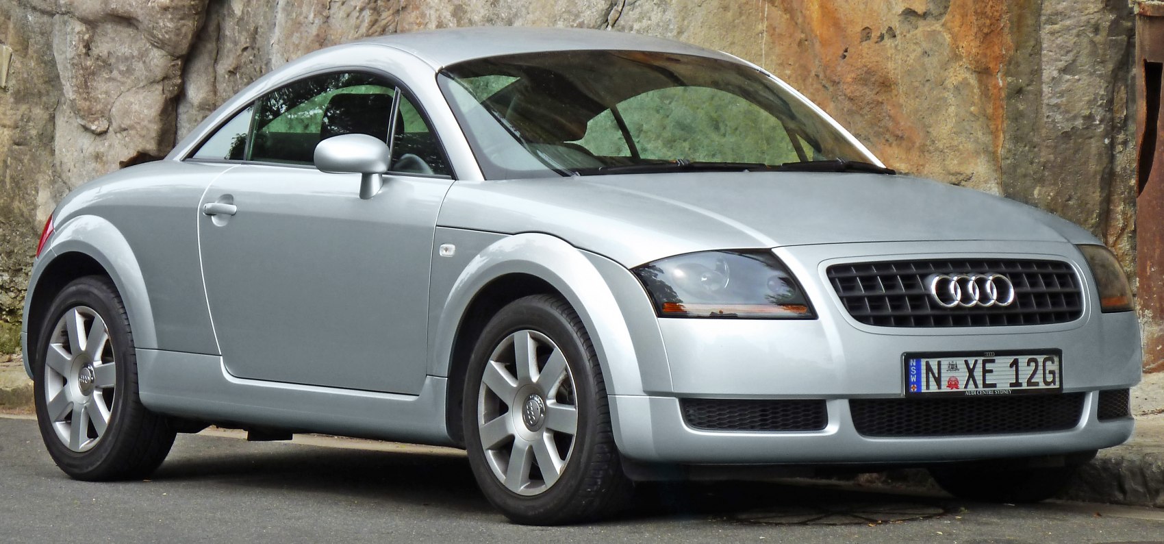 Silver coupe with rounded headlights and alloy wheels.