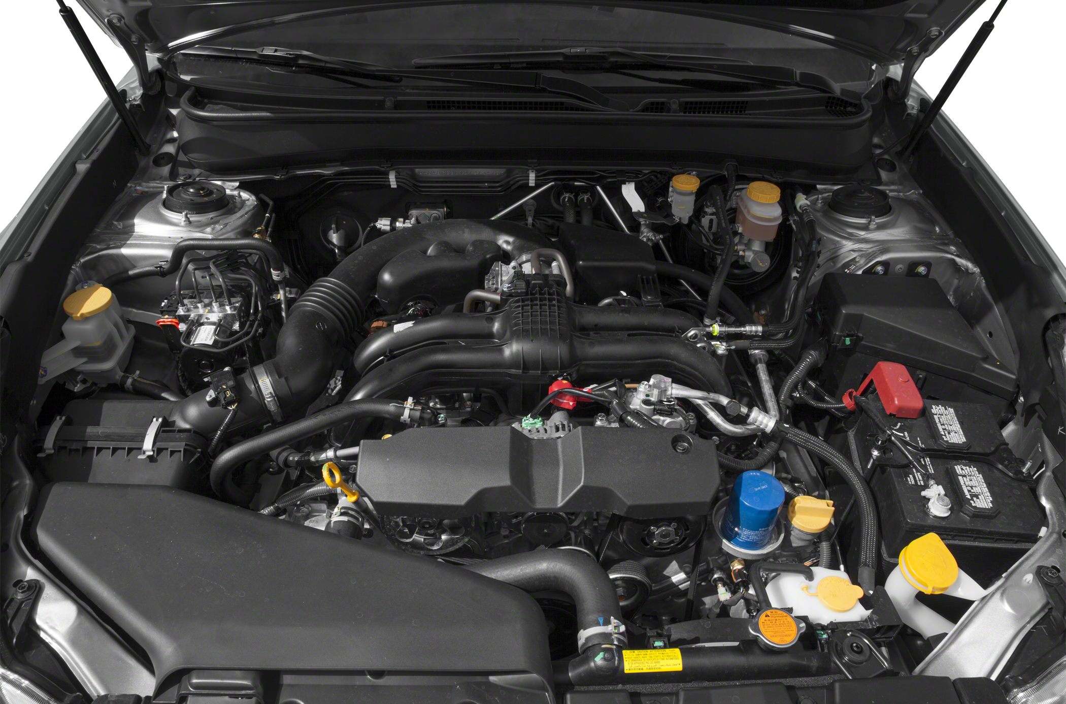 Engine bay showing air intake, battery, fluid reservoirs, and engine cover