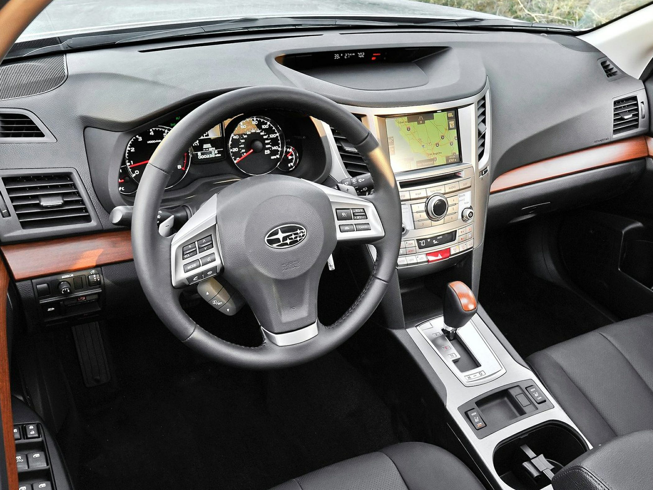 Car interior with navigation screen, wood trim, and central console