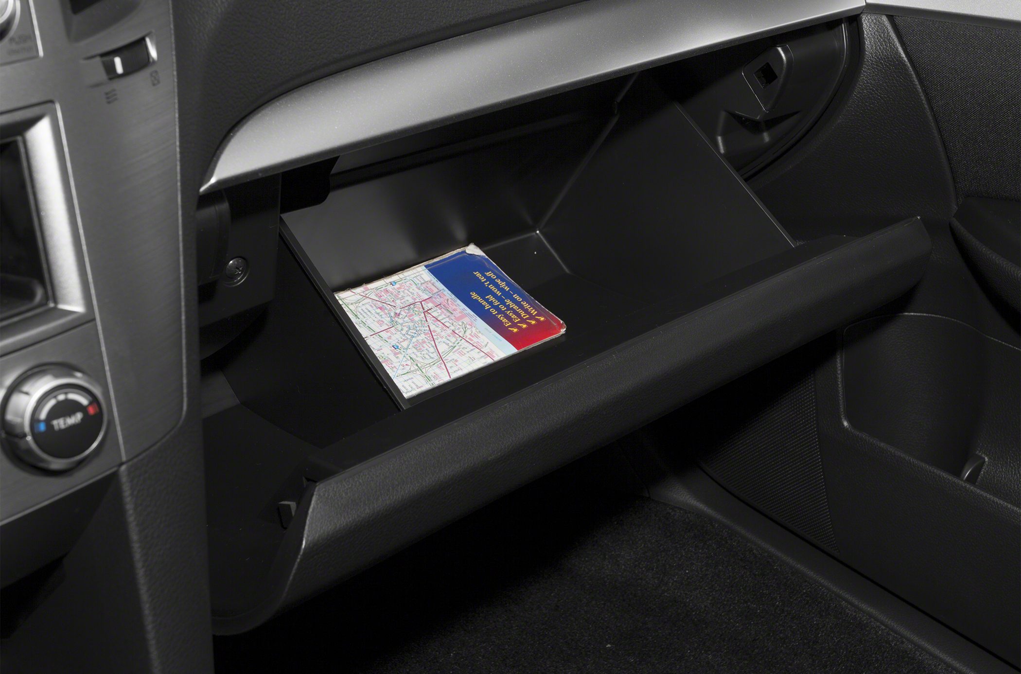 Open glove box with map inside car interior