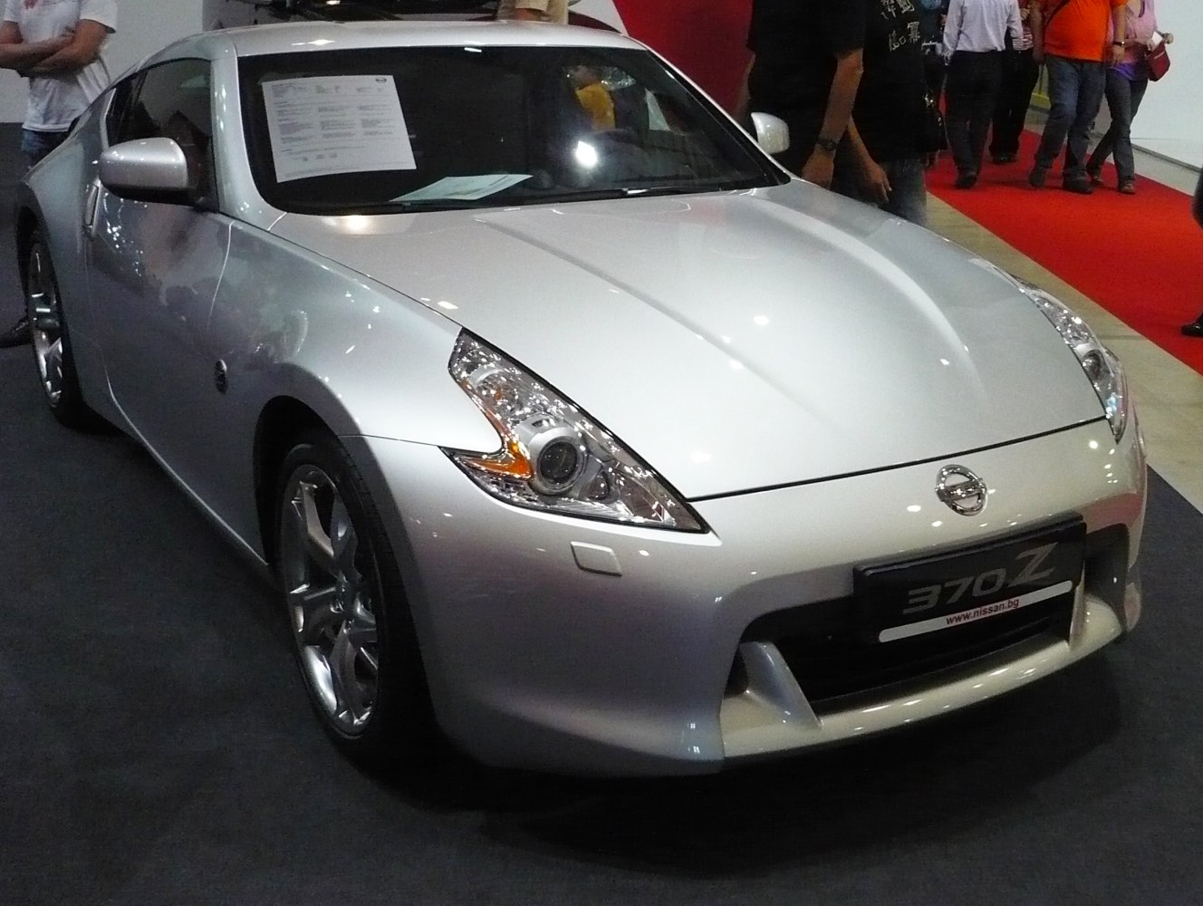 Silver sports coupe with aerodynamic front and sleek headlights