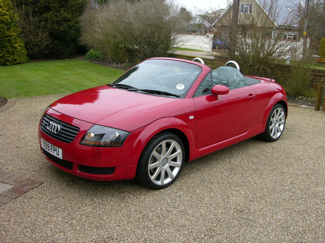 Convertible sports coupe with silver alloy wheels and dual roll bars