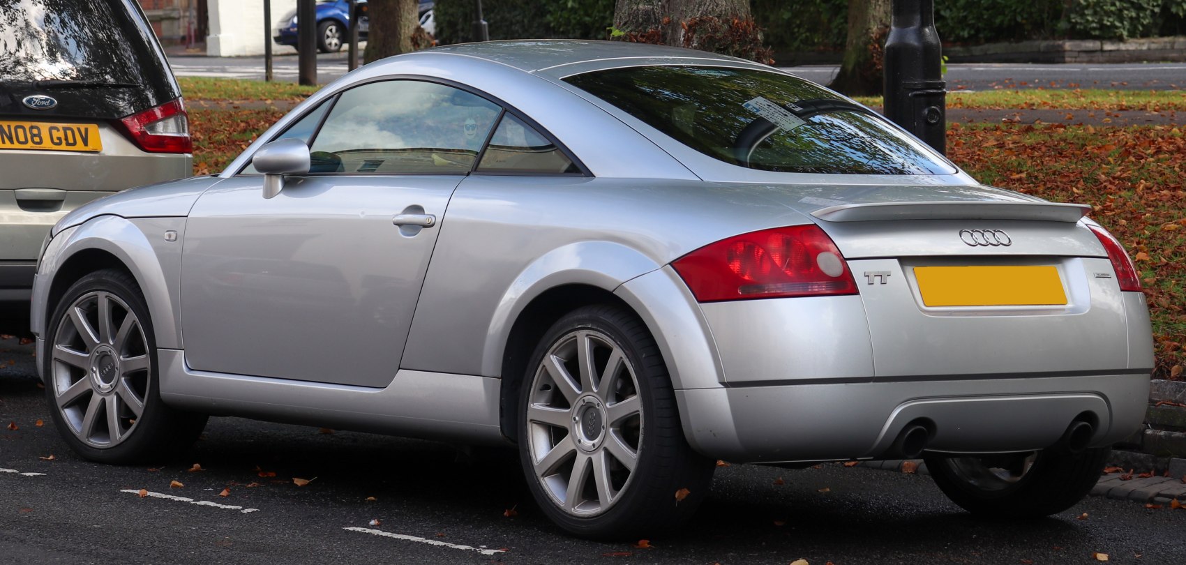 Rear and side profile of silver coupe with curved roof and alloy wheels