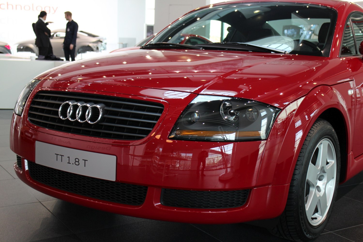Front grille, headlights, and wheel of sporty coupe