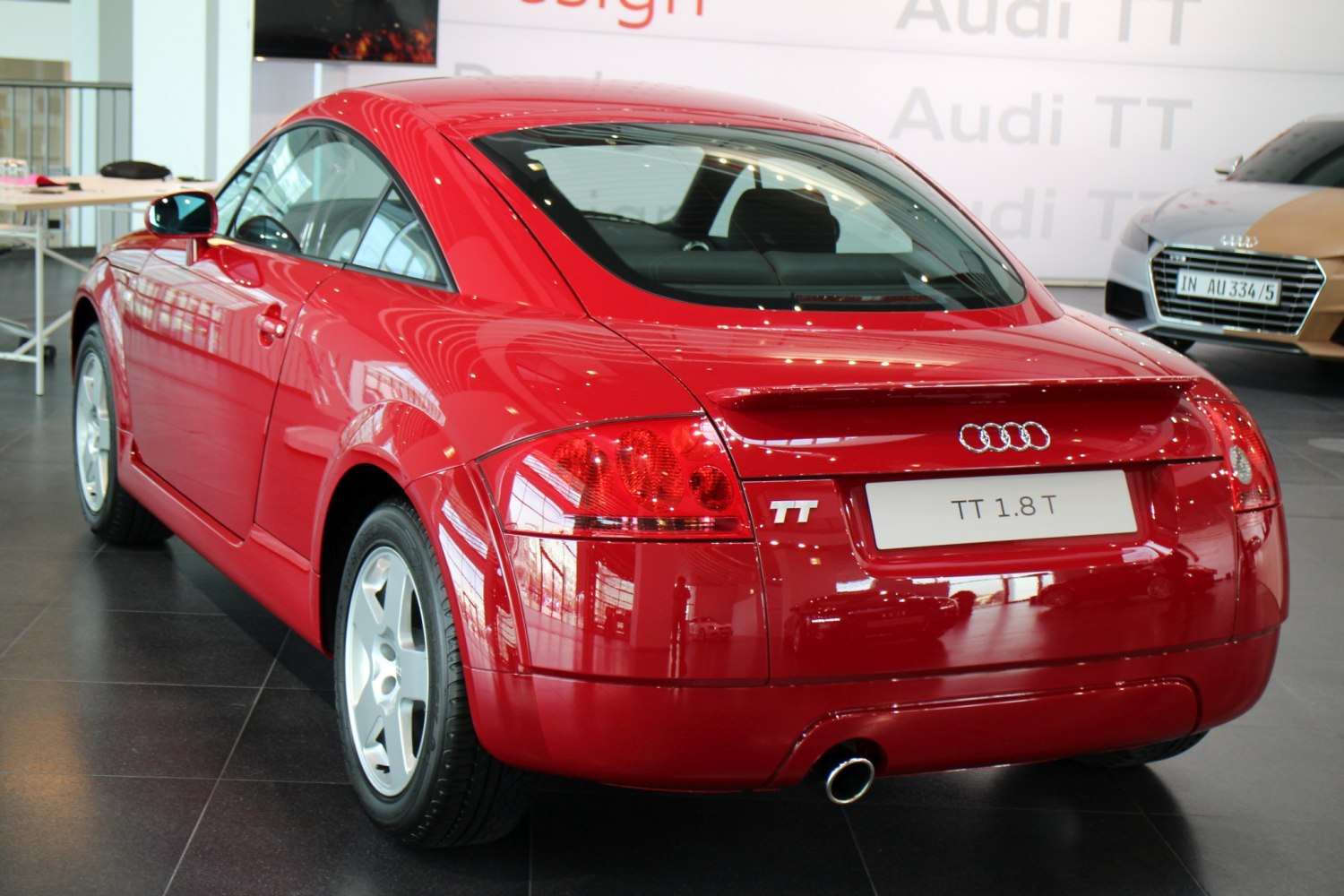 Rear view of red coupe with spoiler and distinctive taillights