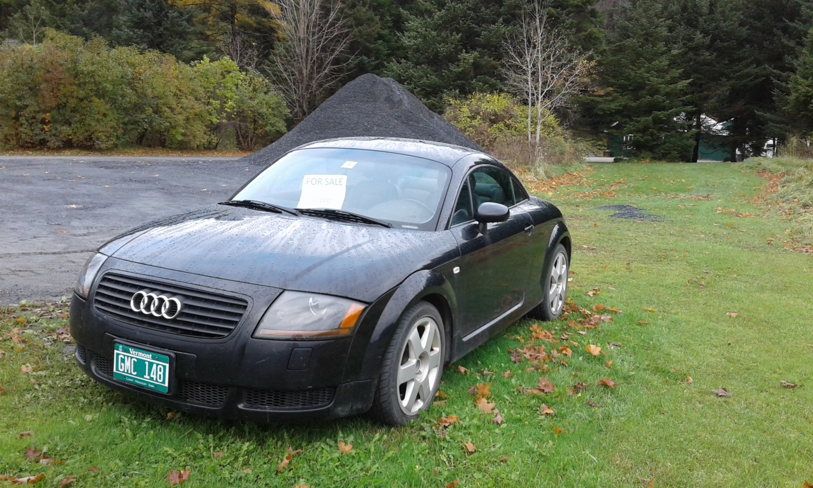 Front 3/4 view of black coupe with Audi grille and alloy wheels