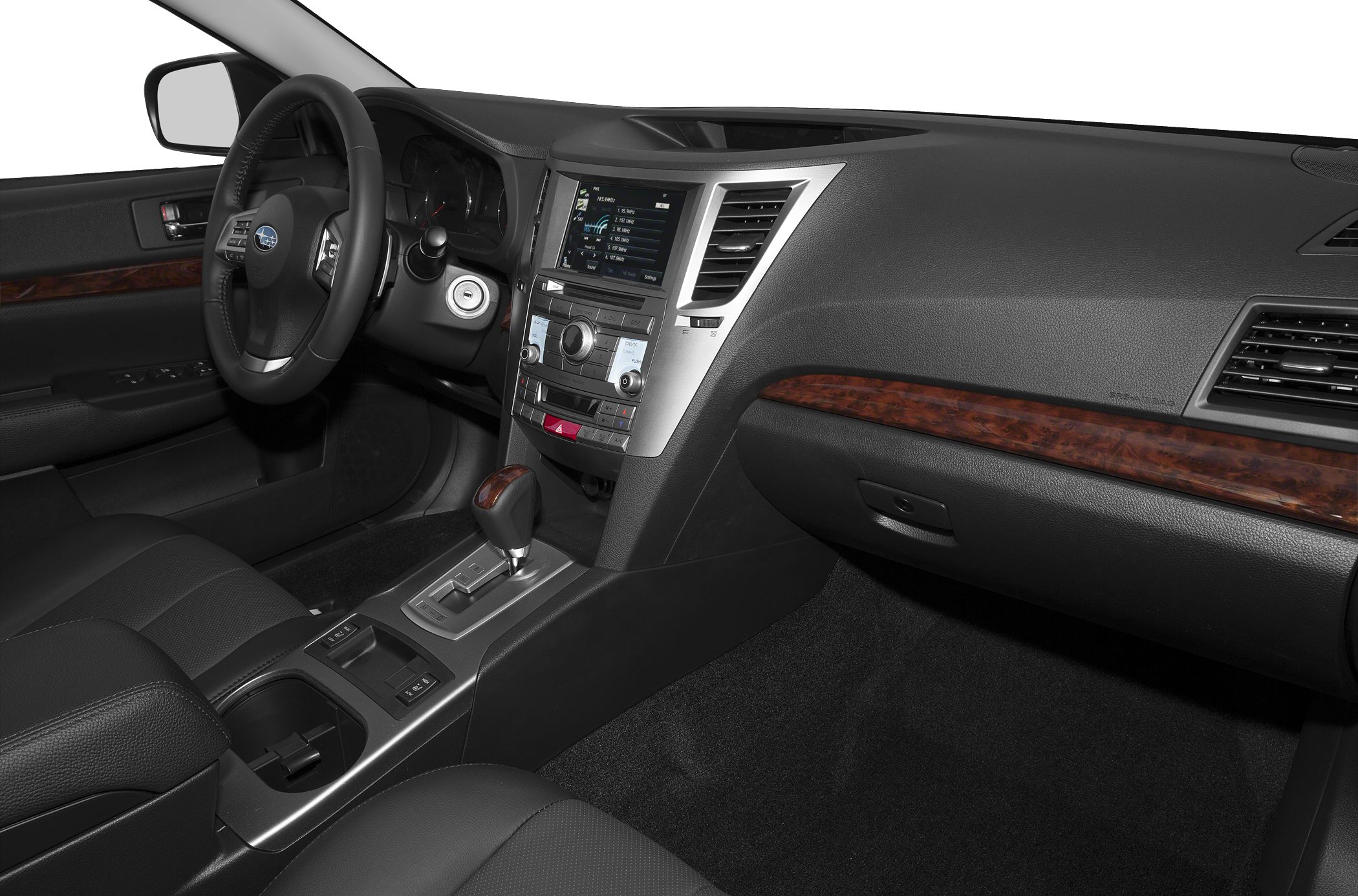 Dashboard, infotainment center, steering wheel, gearshift with wood trim accents