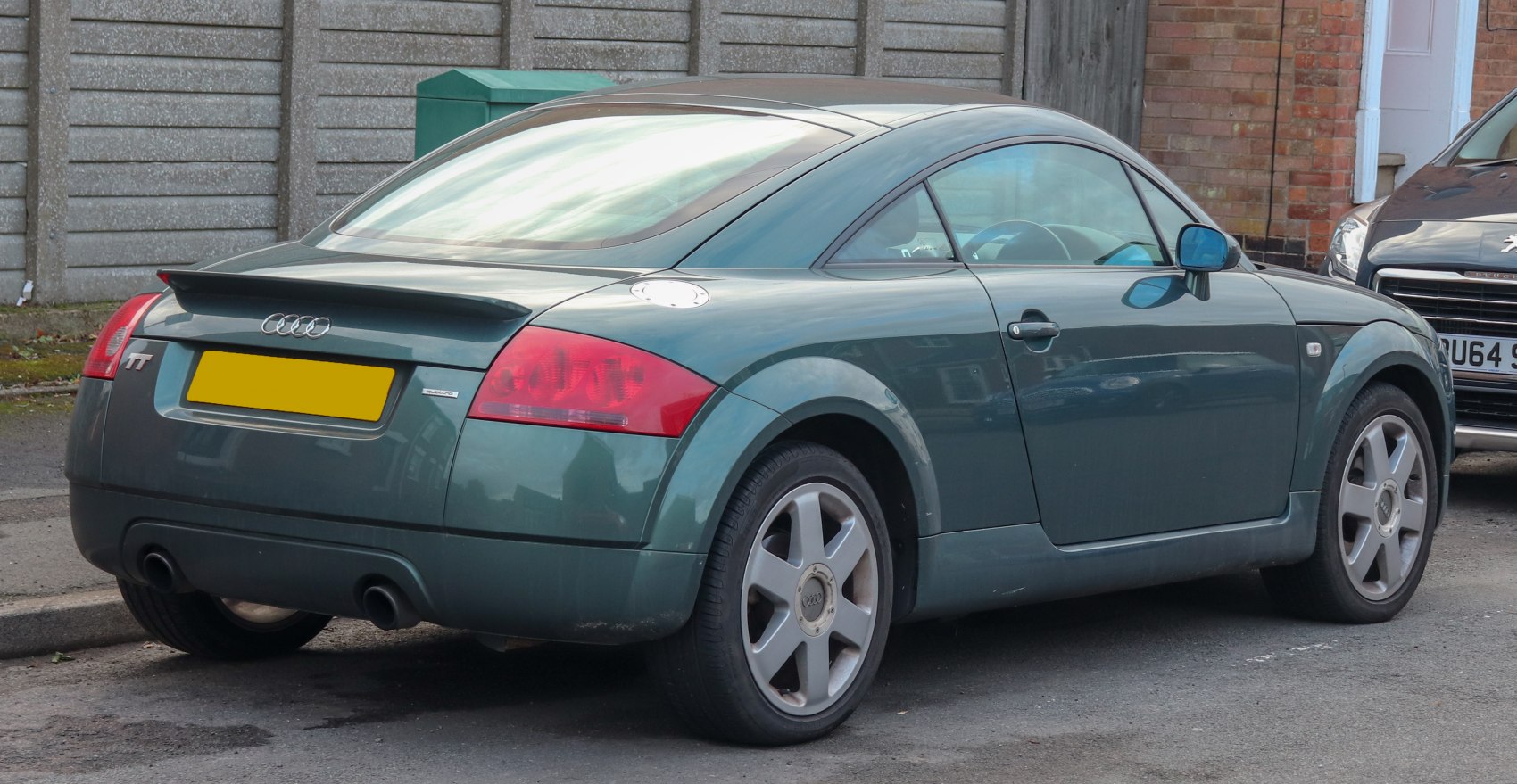 Rear view of compact coupe with distinctive taillights and rear spoiler