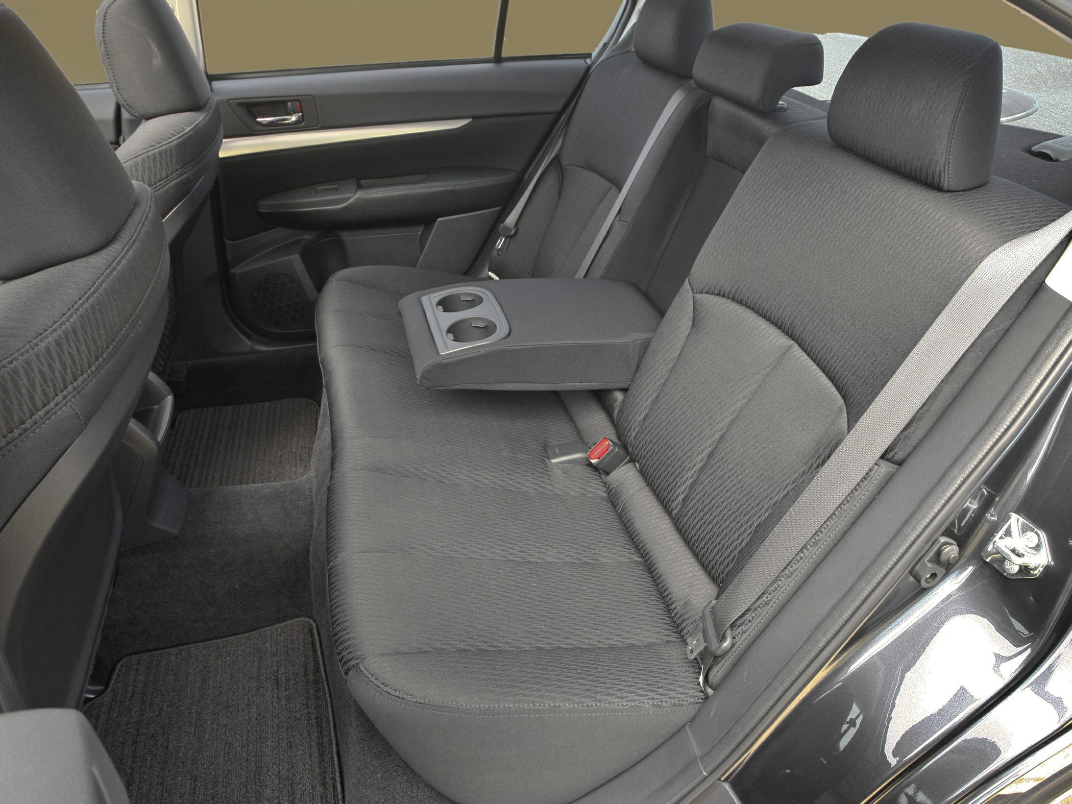 Rear seat with fold-down armrest and cup holders