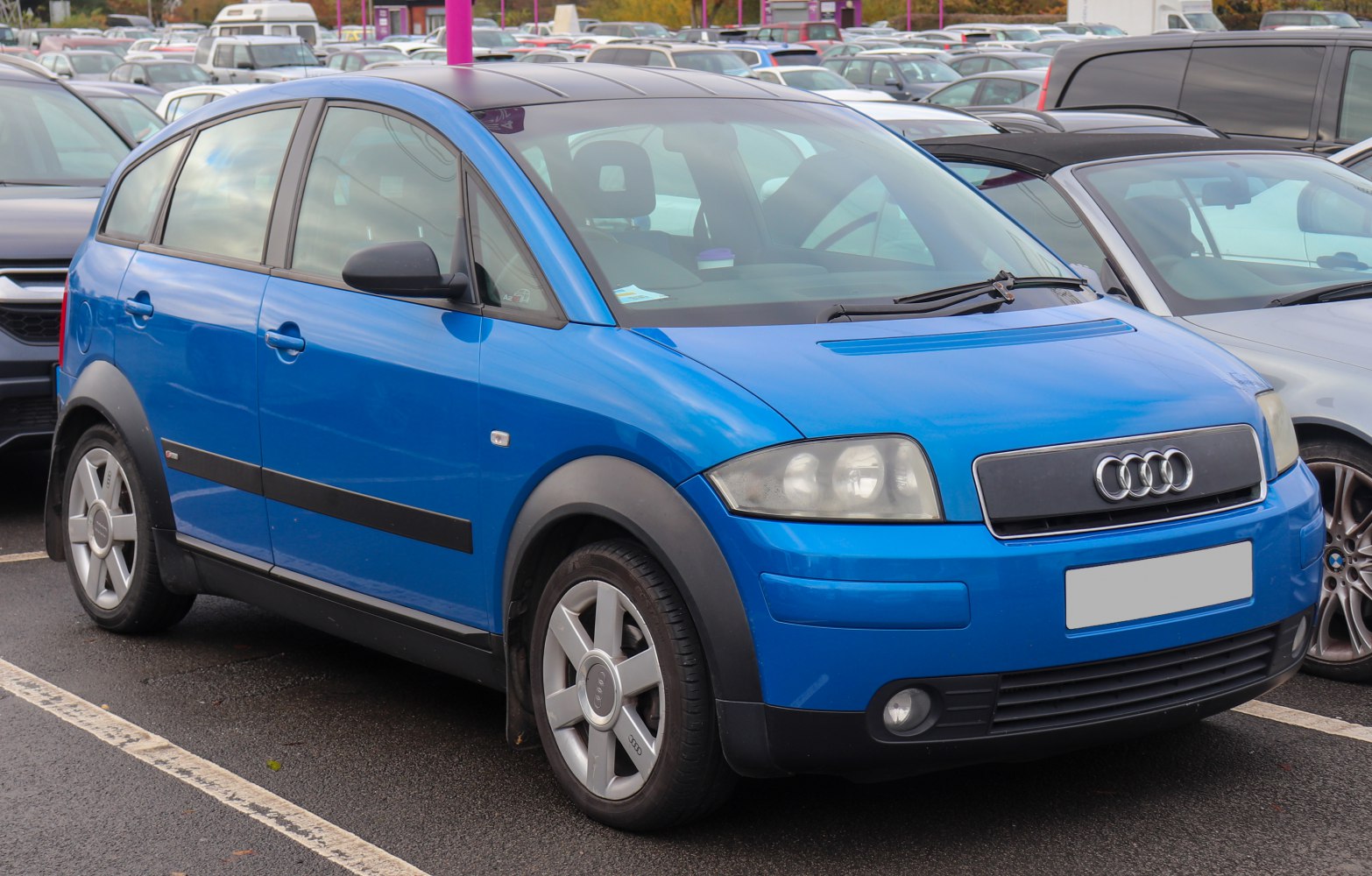 Blue compact hatchback with plastic wheel arches and distinctive front grille