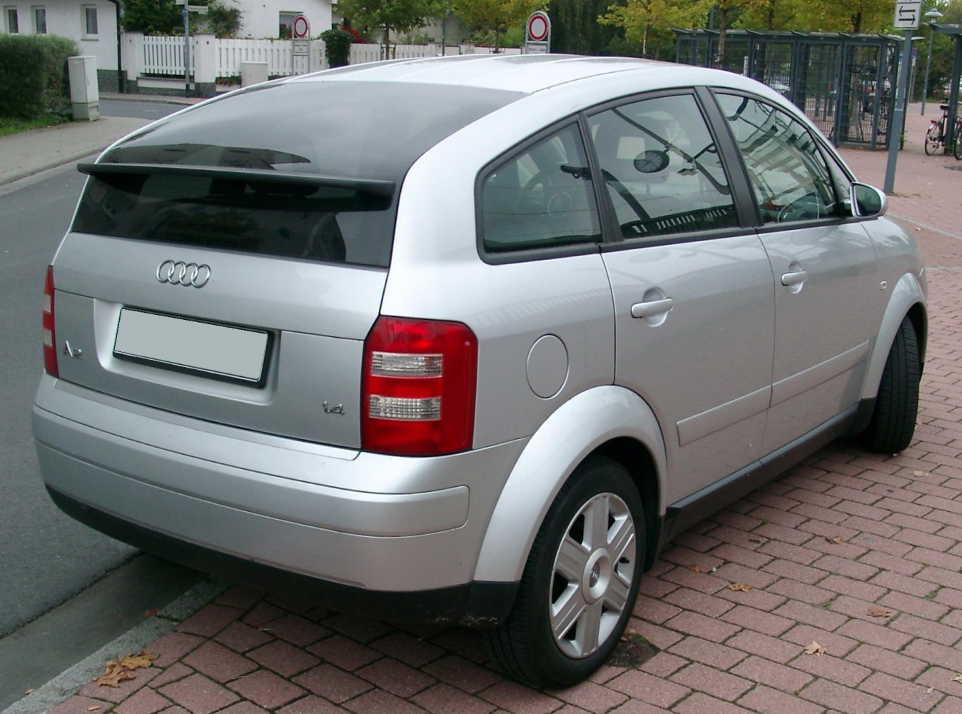 Silver hatchback rear side with distinct taillights and curved rear window