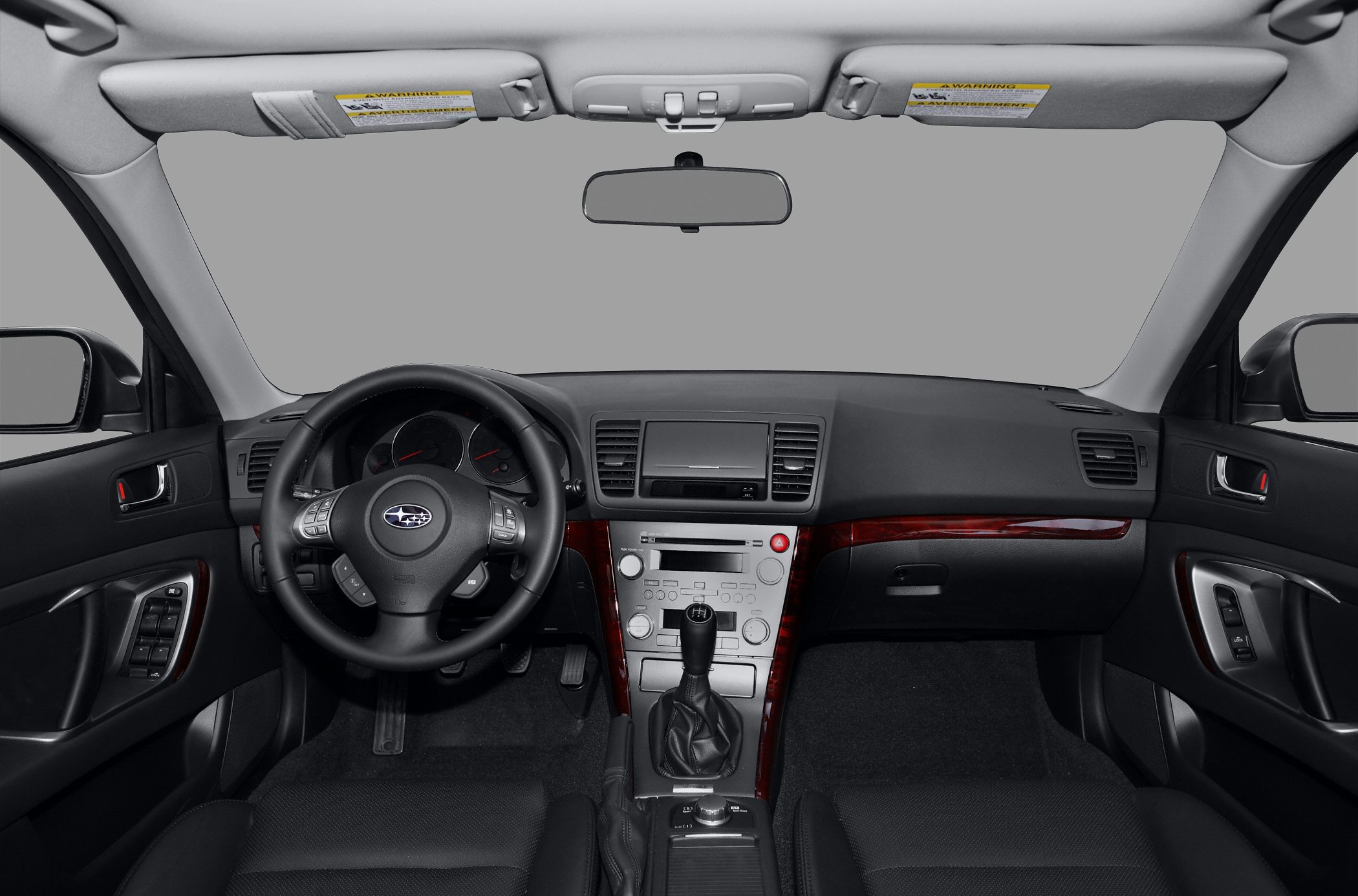 Interior dashboard with steering wheel, center console, and manual gear shift.
