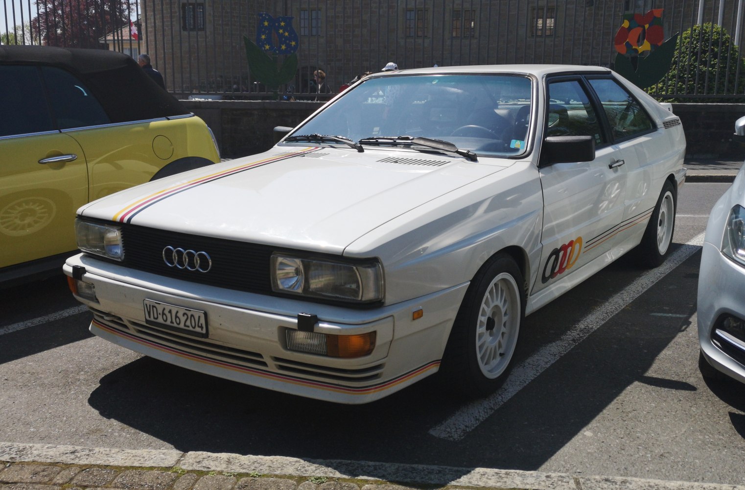White coupe with racing stripes and iconic styling details