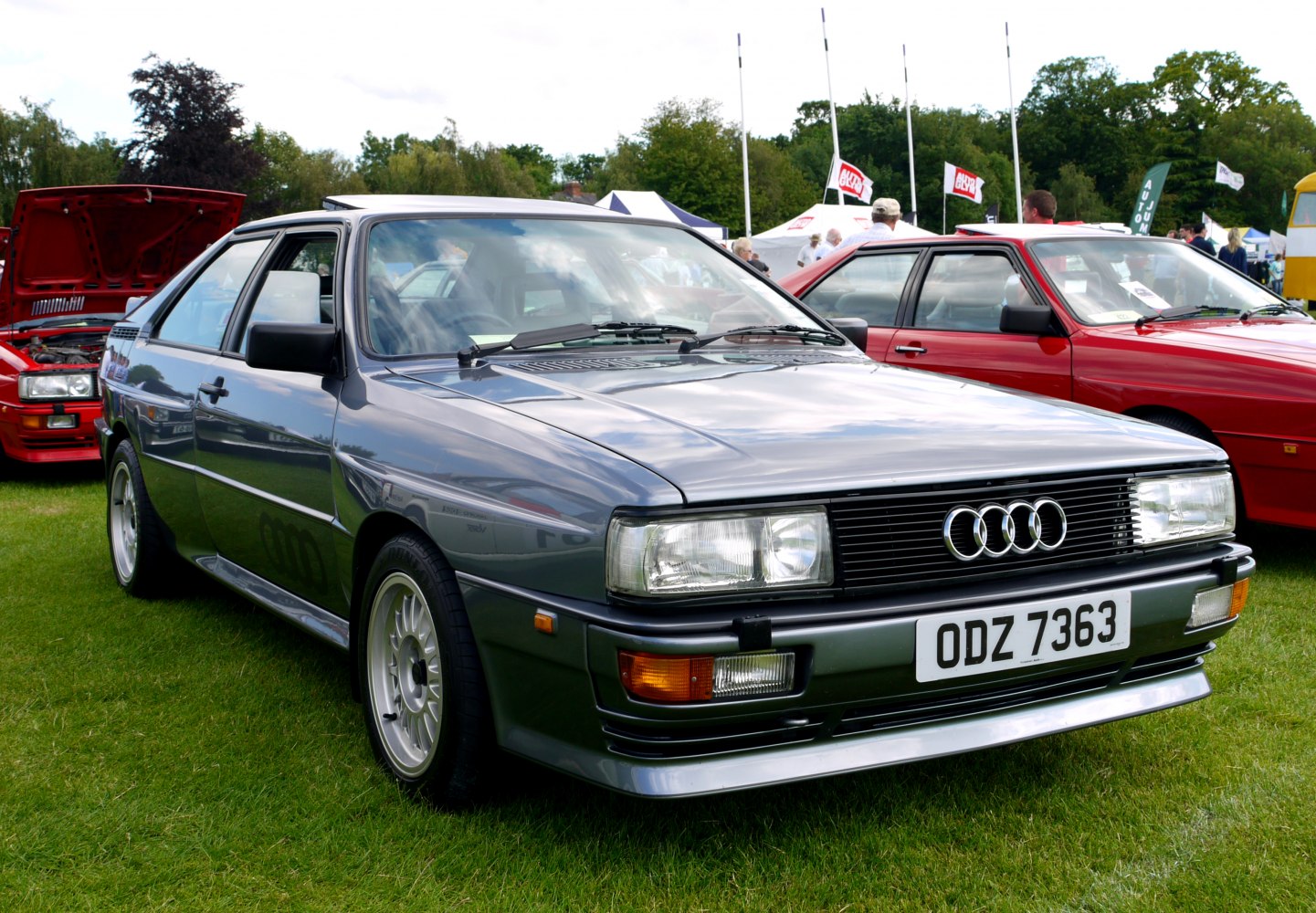 Front profile of classic 1980s coupe with distinctive rectangular headlights and Audi logo.