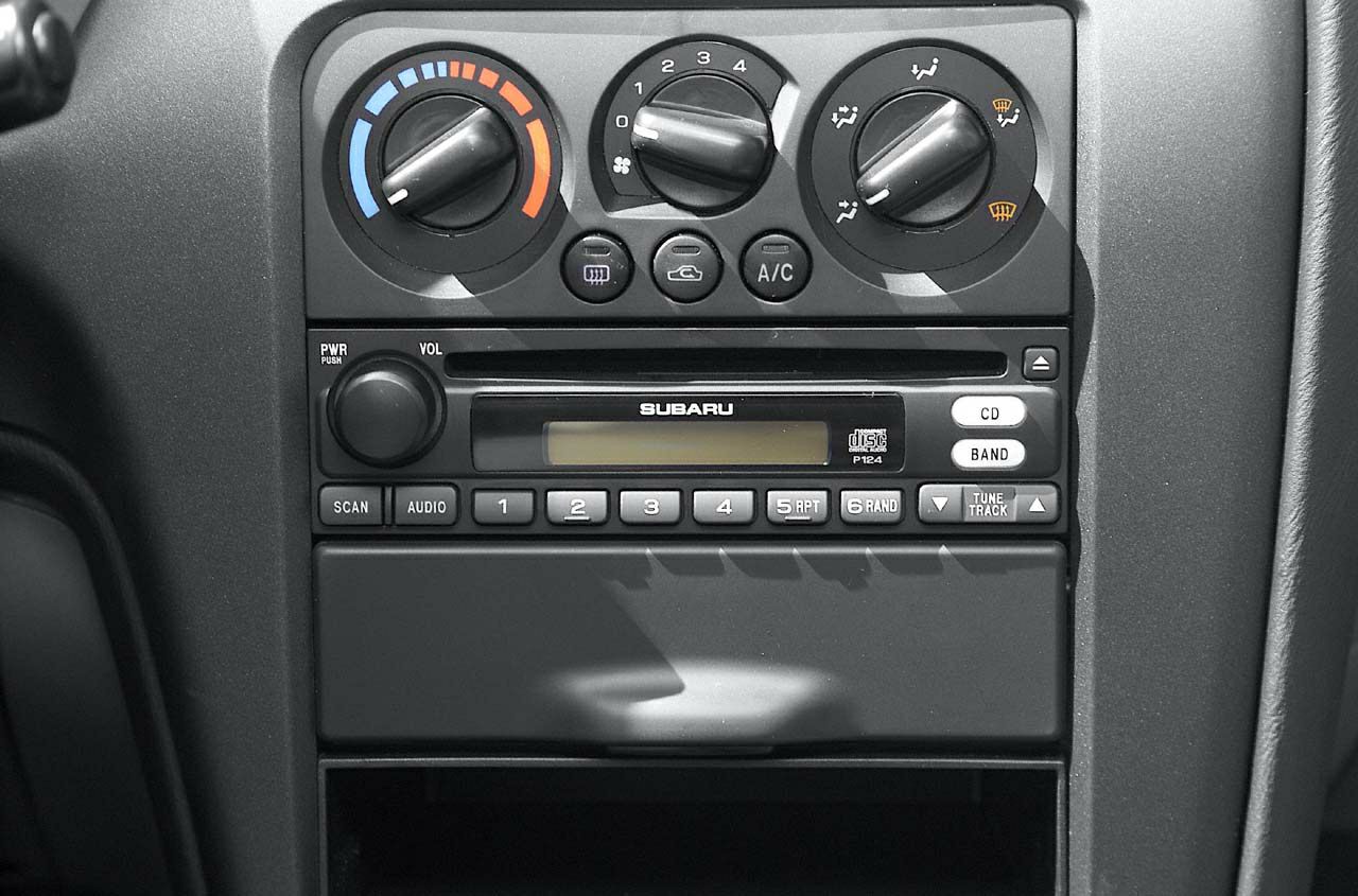 Climate control dials and audio system panel with CD player and radio buttons