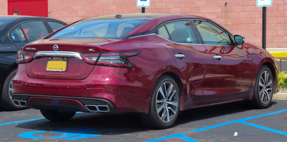 Rear and side profile with tail lights and exhaust of a sedan
