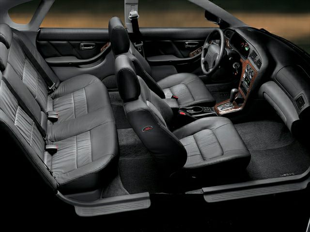 Car interior with black leather seats and wood grain trim