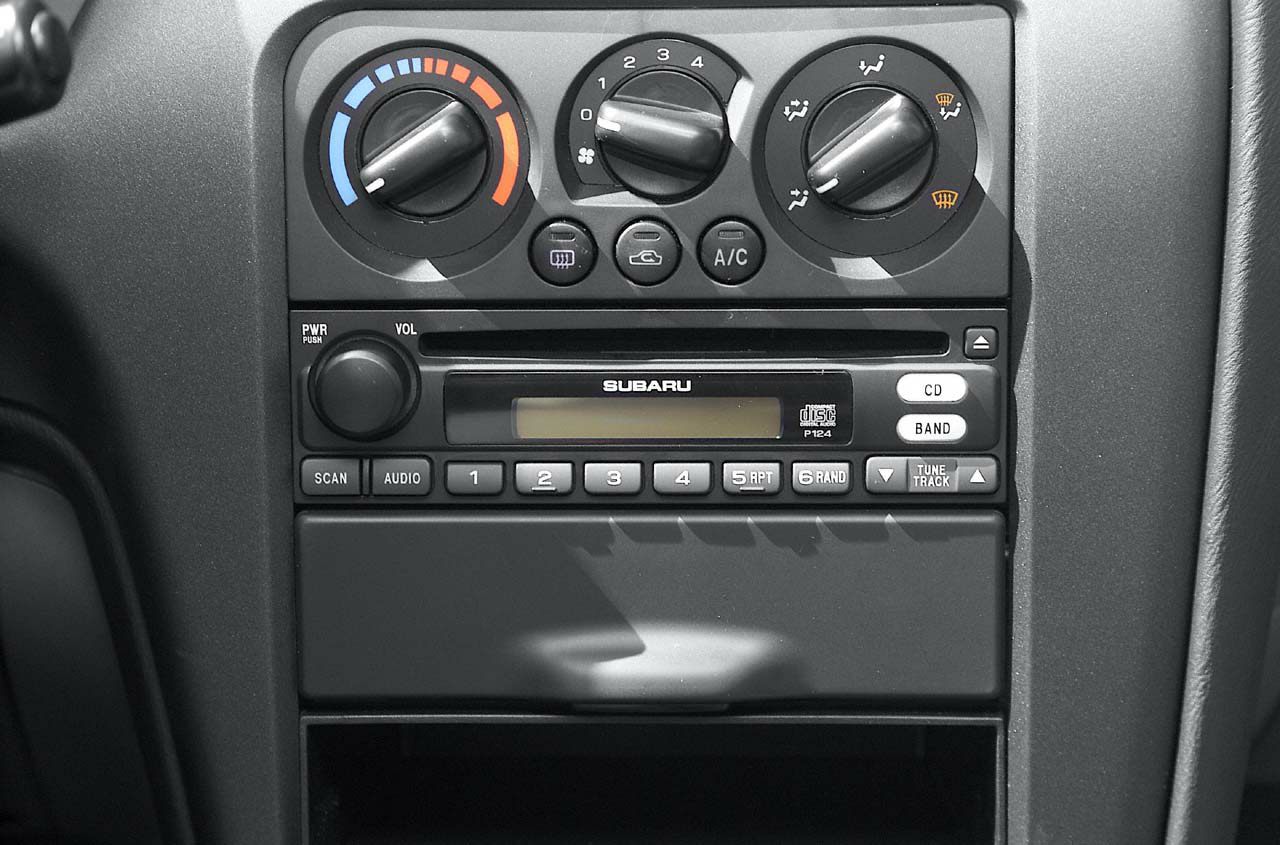 Car stereo unit and manual climate controls close-up