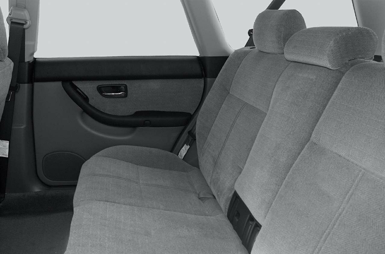 Fabric rear bench seat and door panel with armrest and speaker.