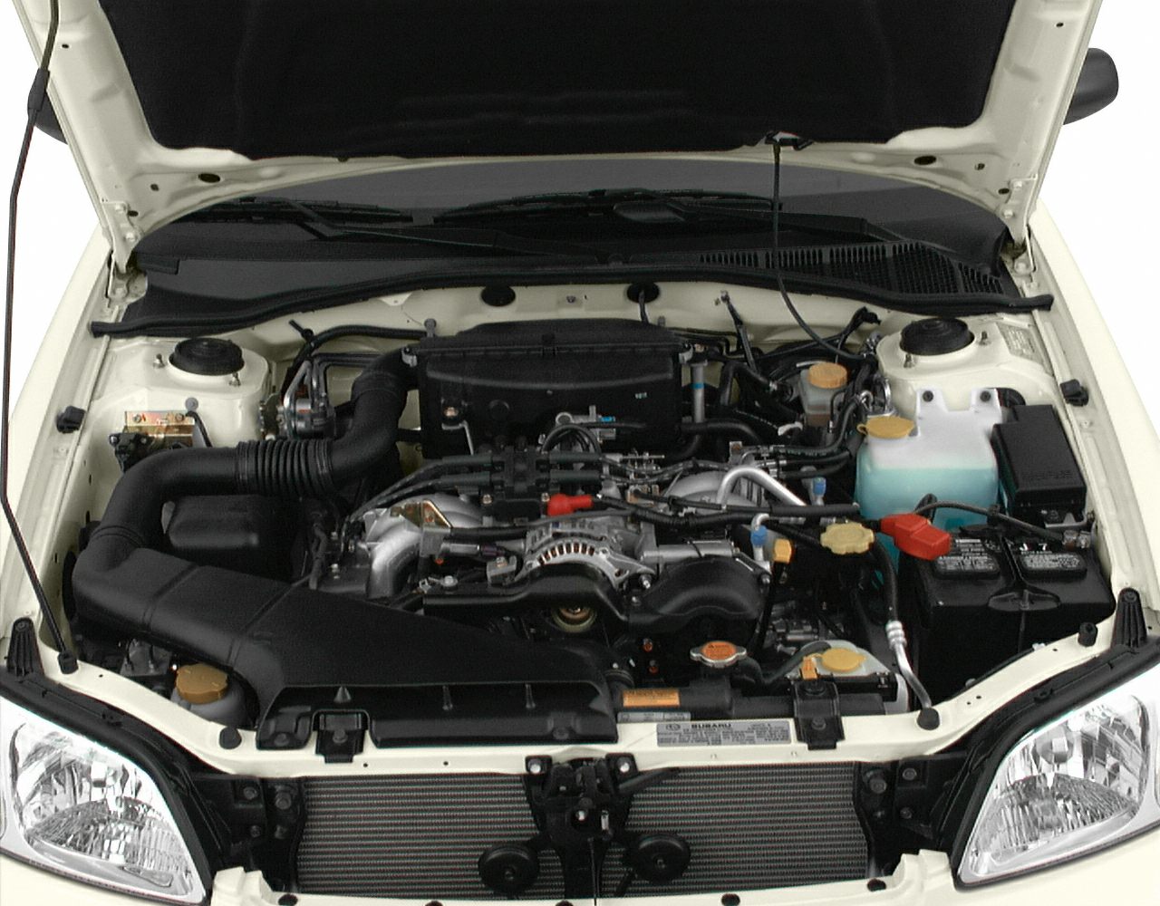 Close-up of Subaru Legacy III engine bay with visible components and layout.