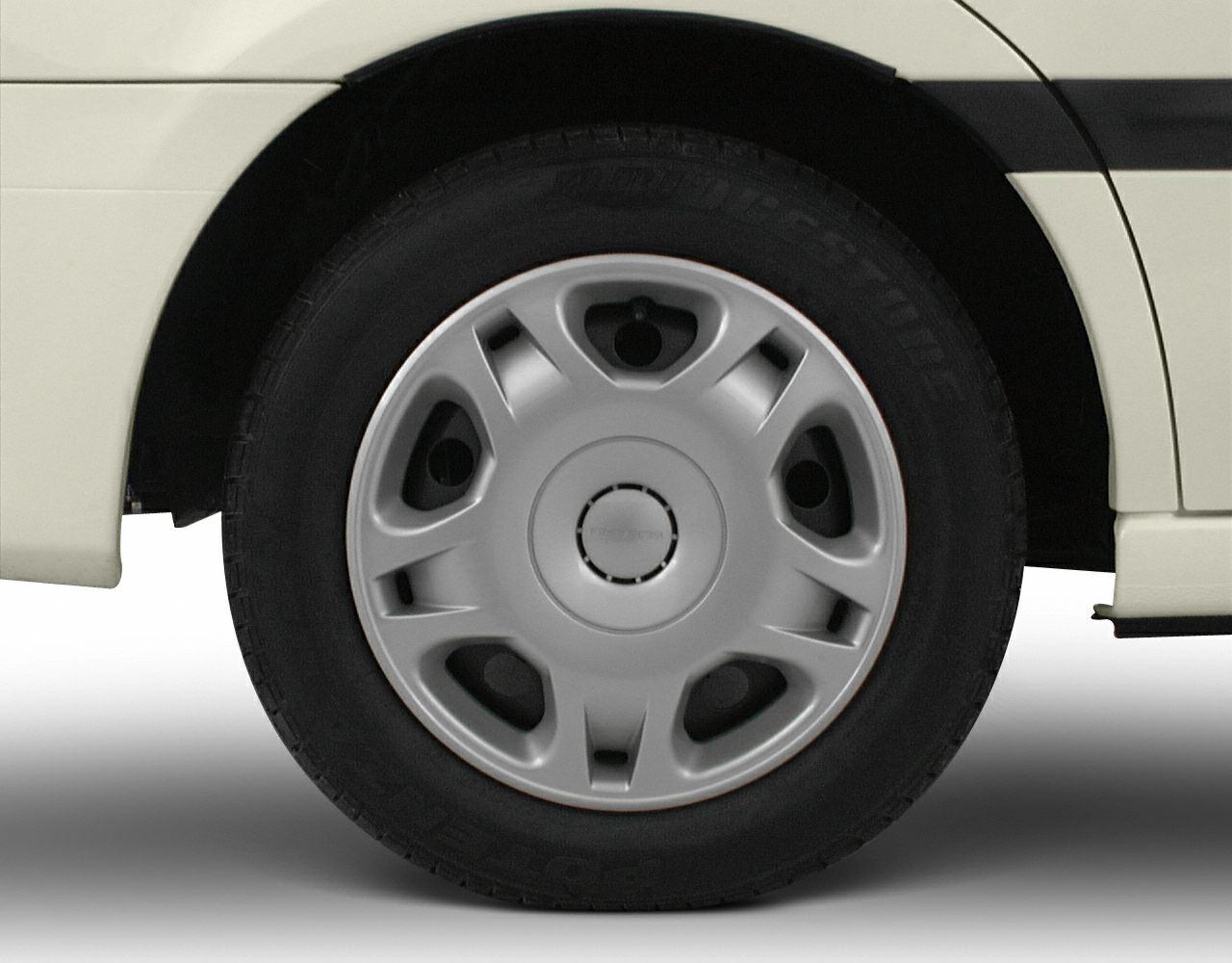 Close-up of alloy wheel and tire from a vintage sedan.
