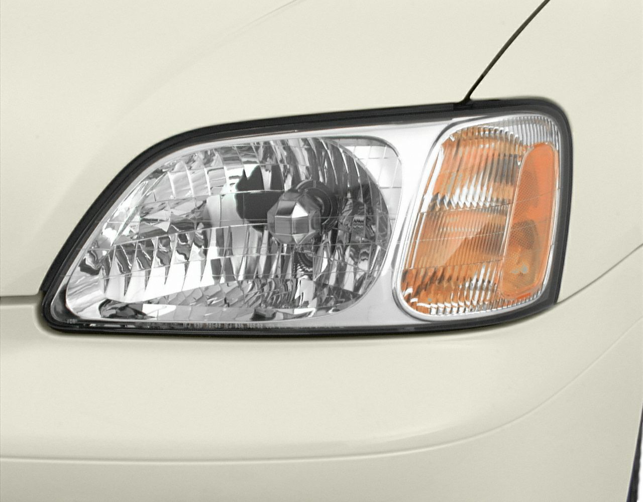 Close-up of headlight and amber turn signal assembly