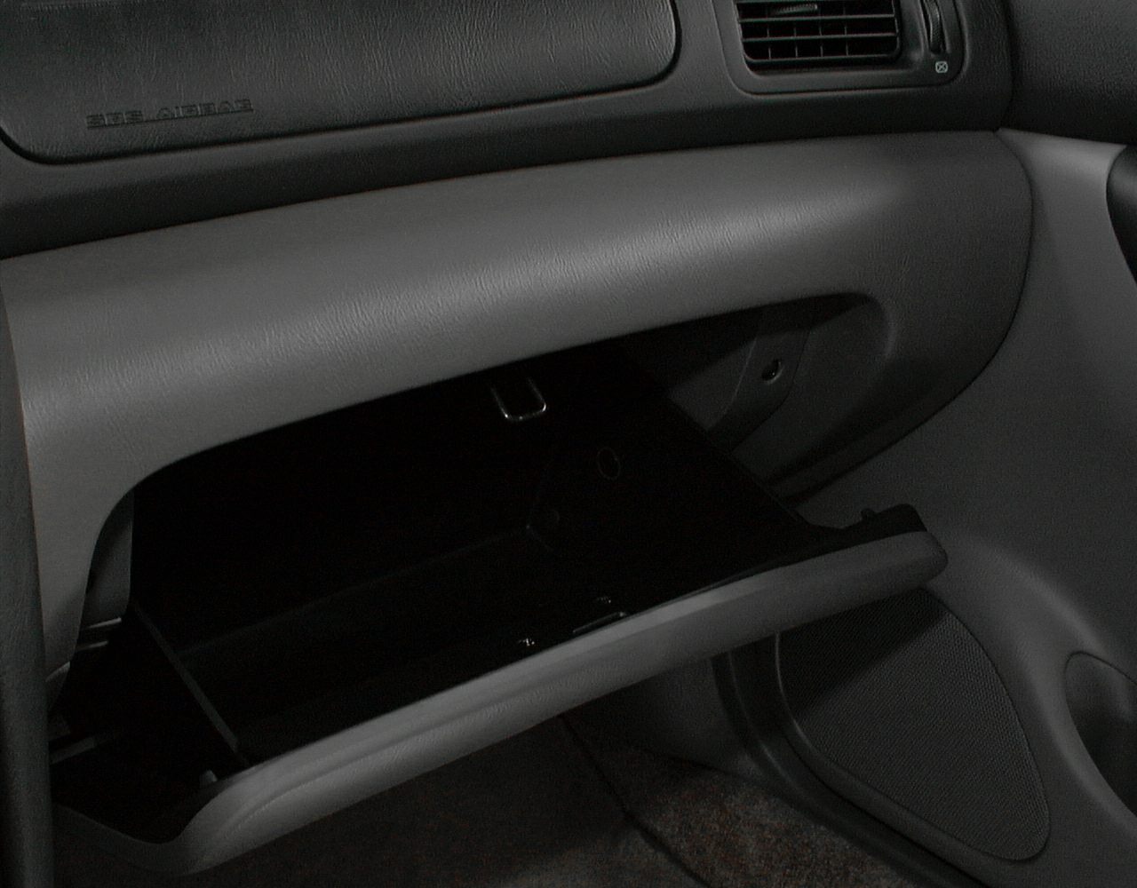 Opened glovebox compartment inside the car dashboard