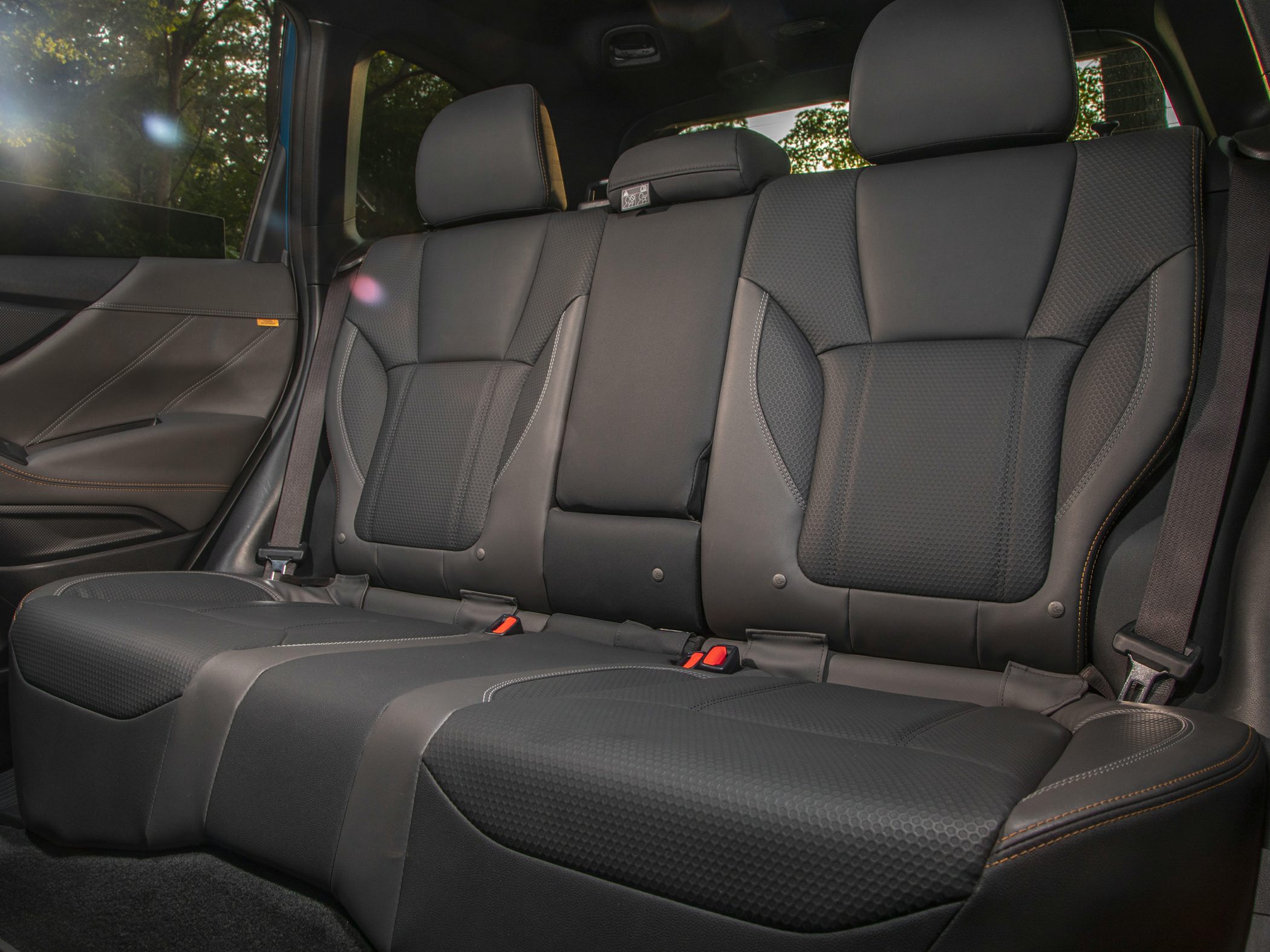 Premium rear seat interior with advanced seatbelt and upholstery.