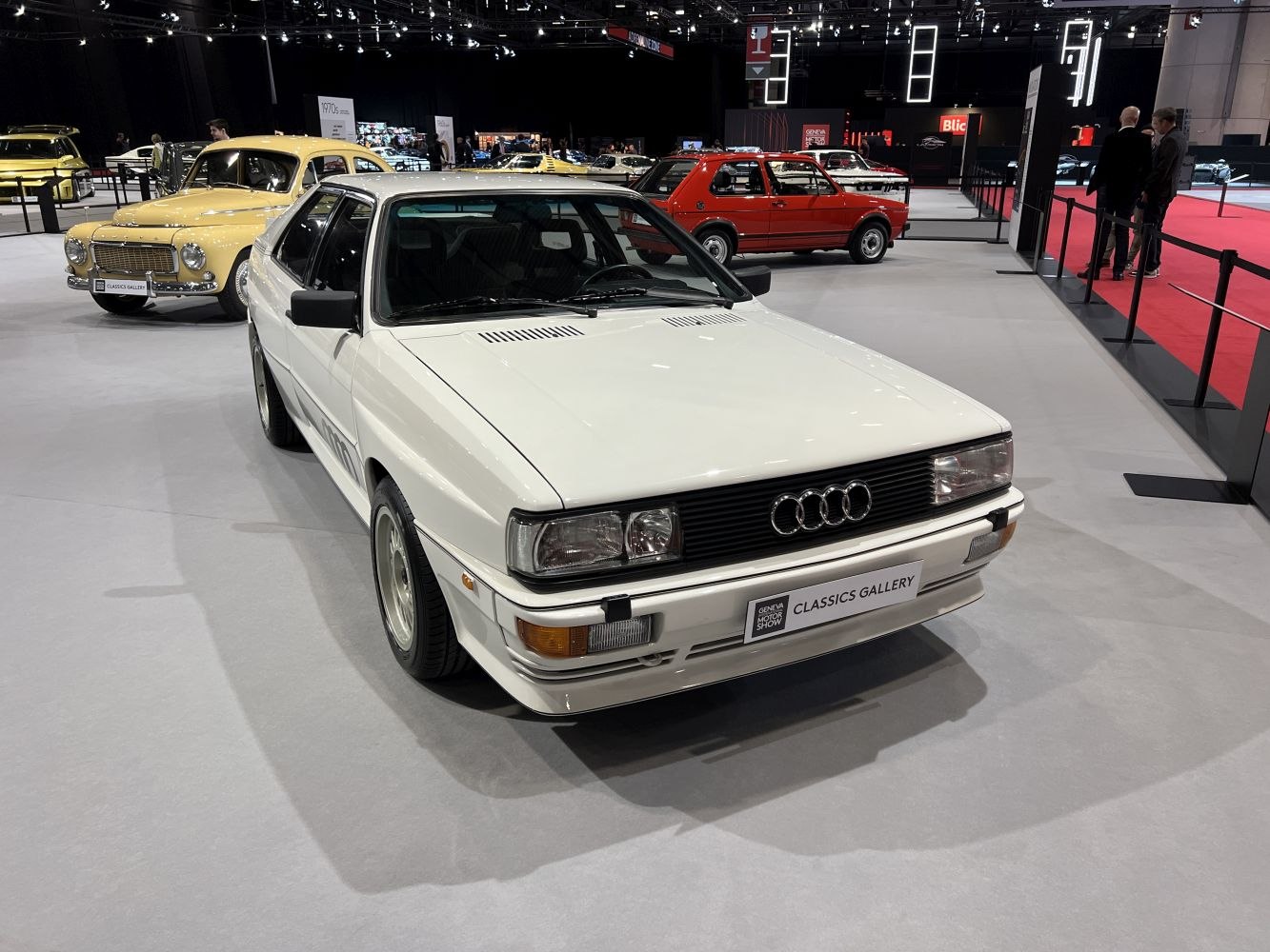 White classic sporty coupe with quad headlights and sharp body lines