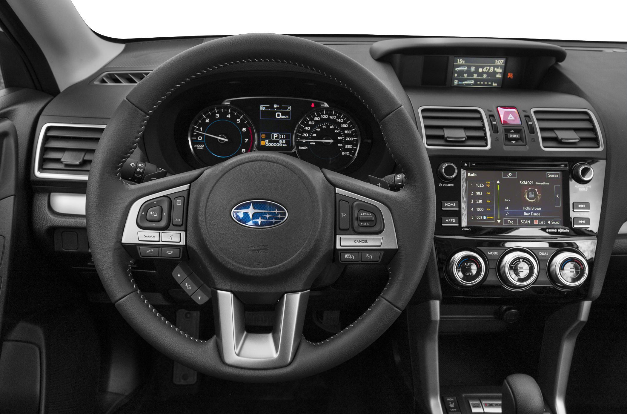 Steering wheel with controls and dashboard display featuring radio and climate control knobs