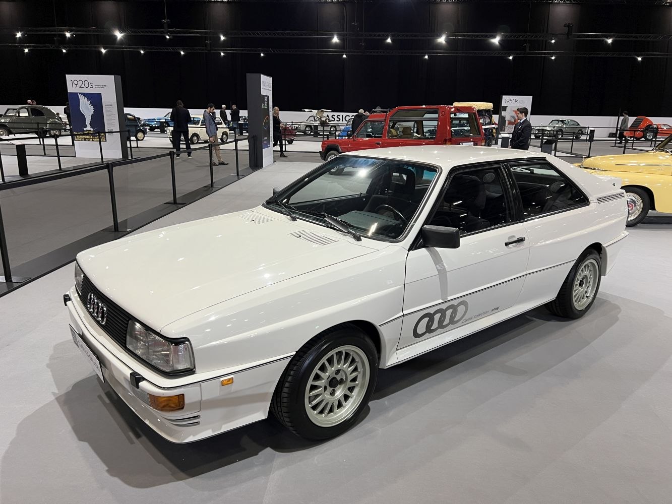 White coupe with spoked alloy wheels and black side decal