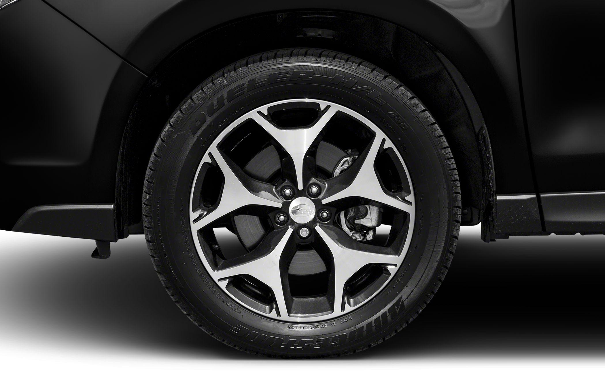 Modern alloy wheel with Bridgestone Dueler H/L tire on an SUV.