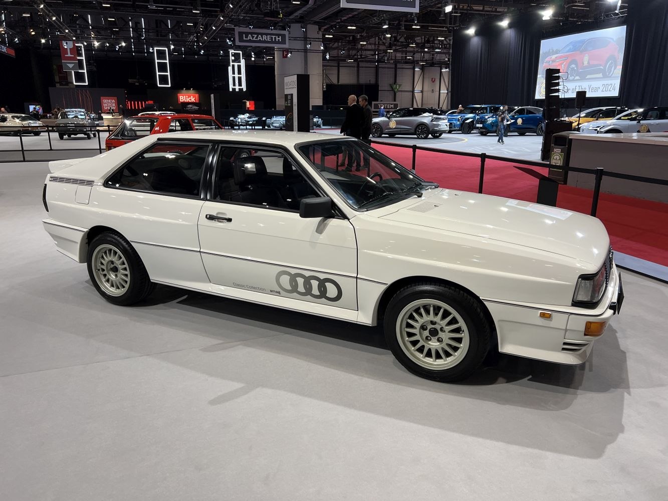 Boxy coupe with classic multi-spoke wheels and rally-inspired design.