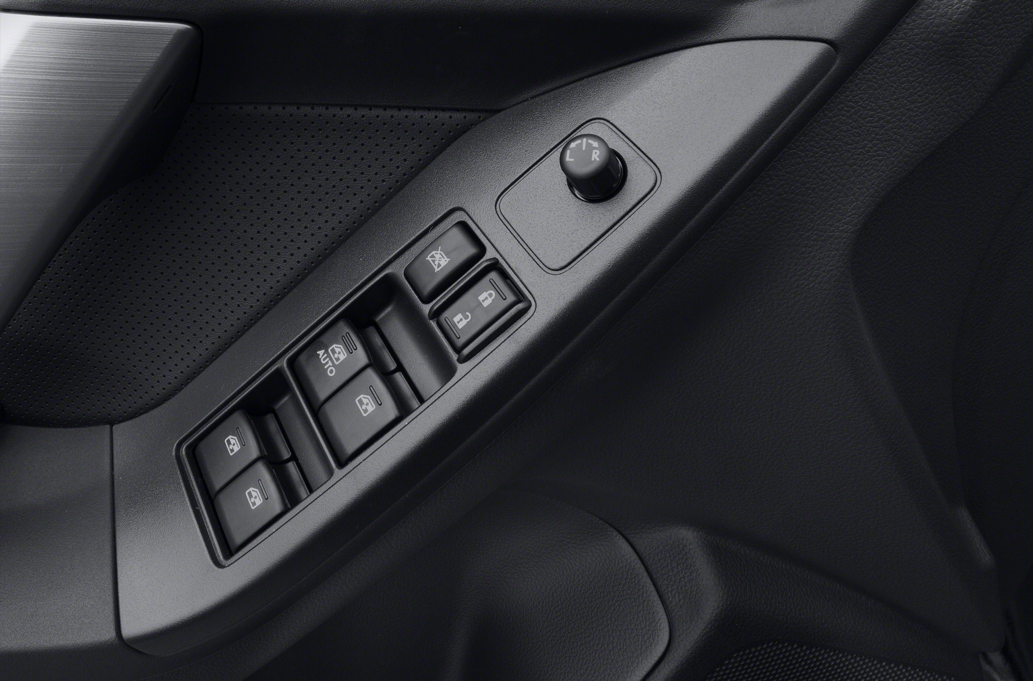 Power window, door lock, and mirror adjustment controls on driver side door panel