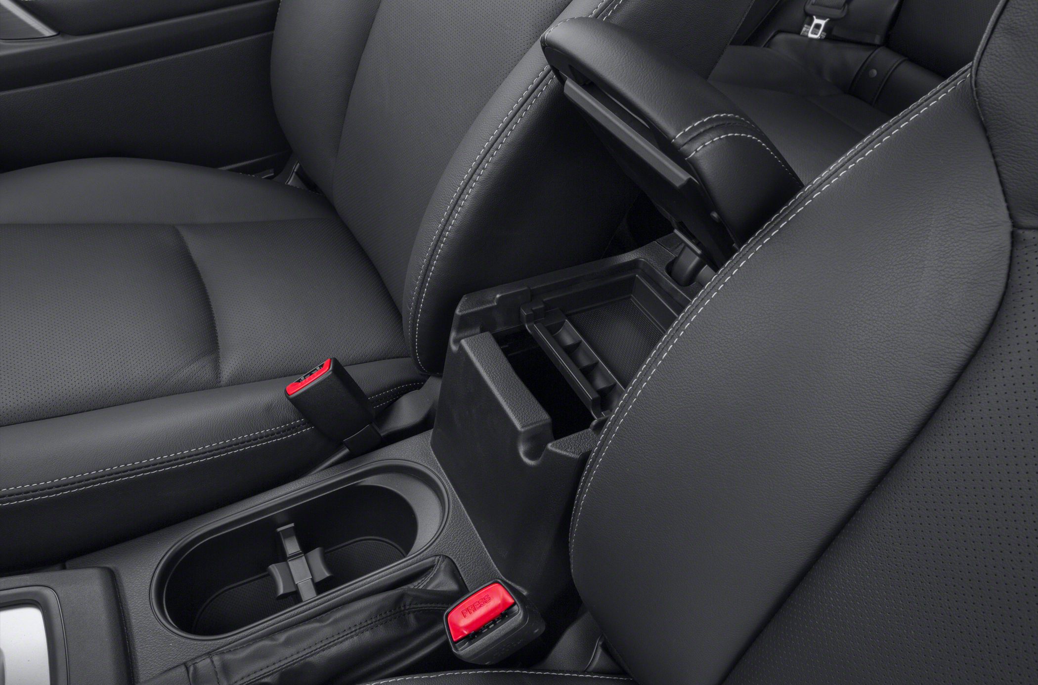Car interior featuring center console, leather seats, armrest storage.