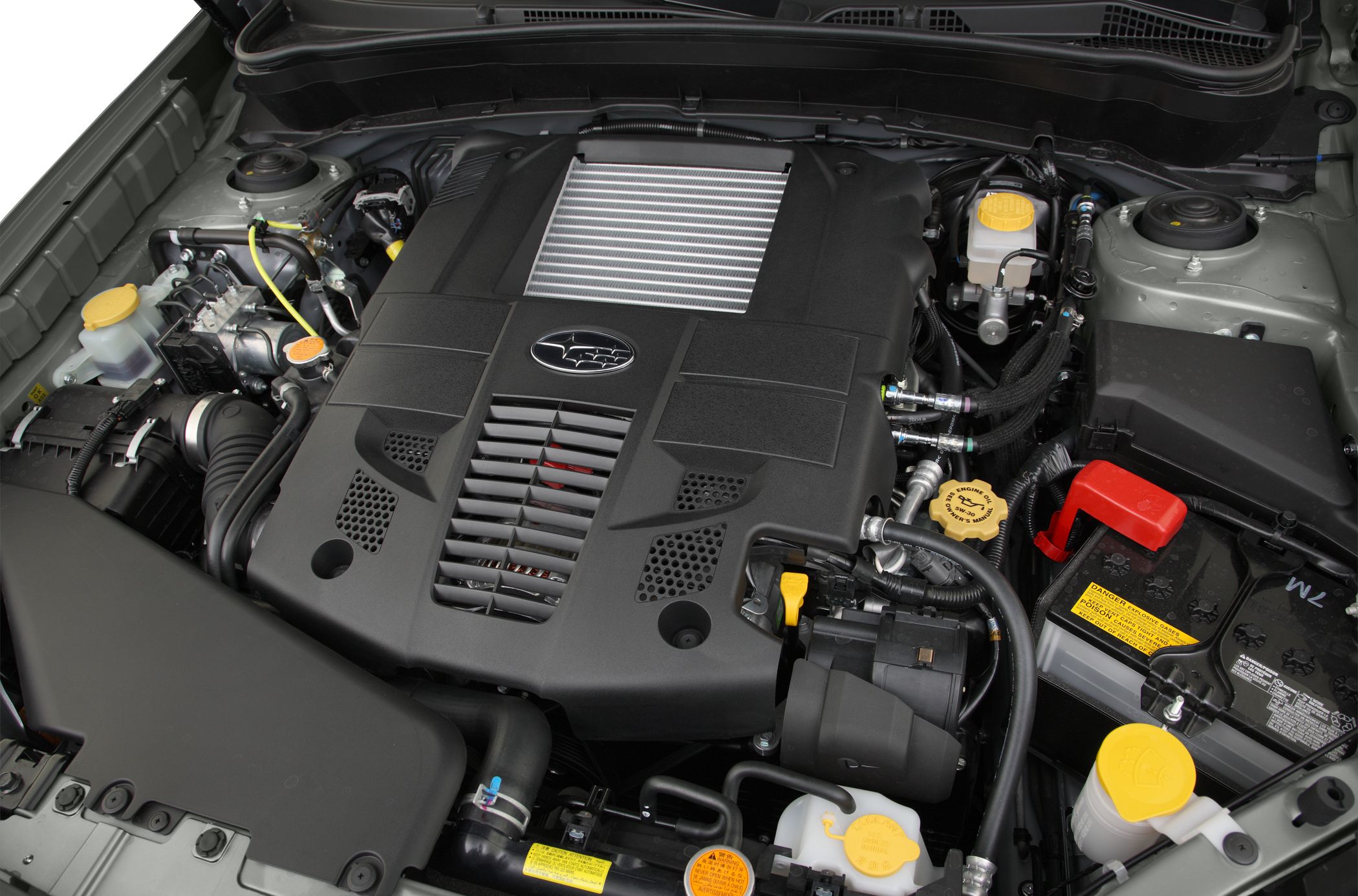 Turbocharged engine with top-mounted intercooler and fluid reservoirs