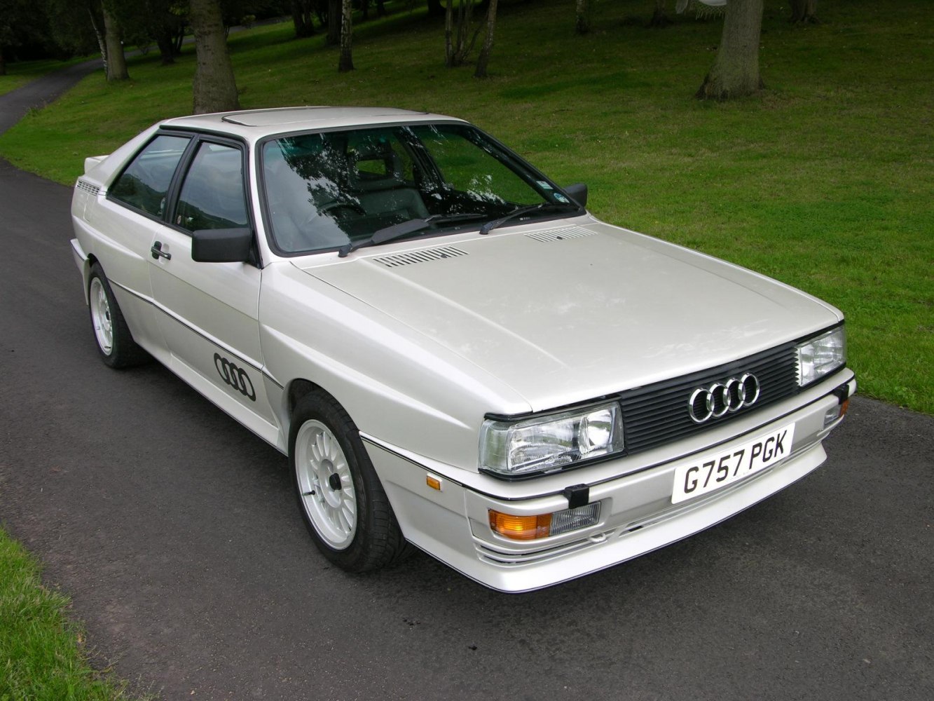 Front side view of an angular classic 1980s coupe with distinctive grill and headlights