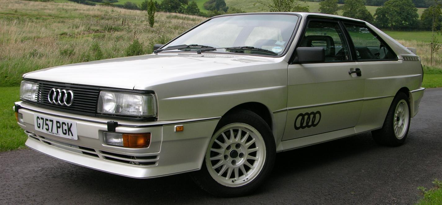 Front side view of classic sport coupe with alloy wheels and signature grille