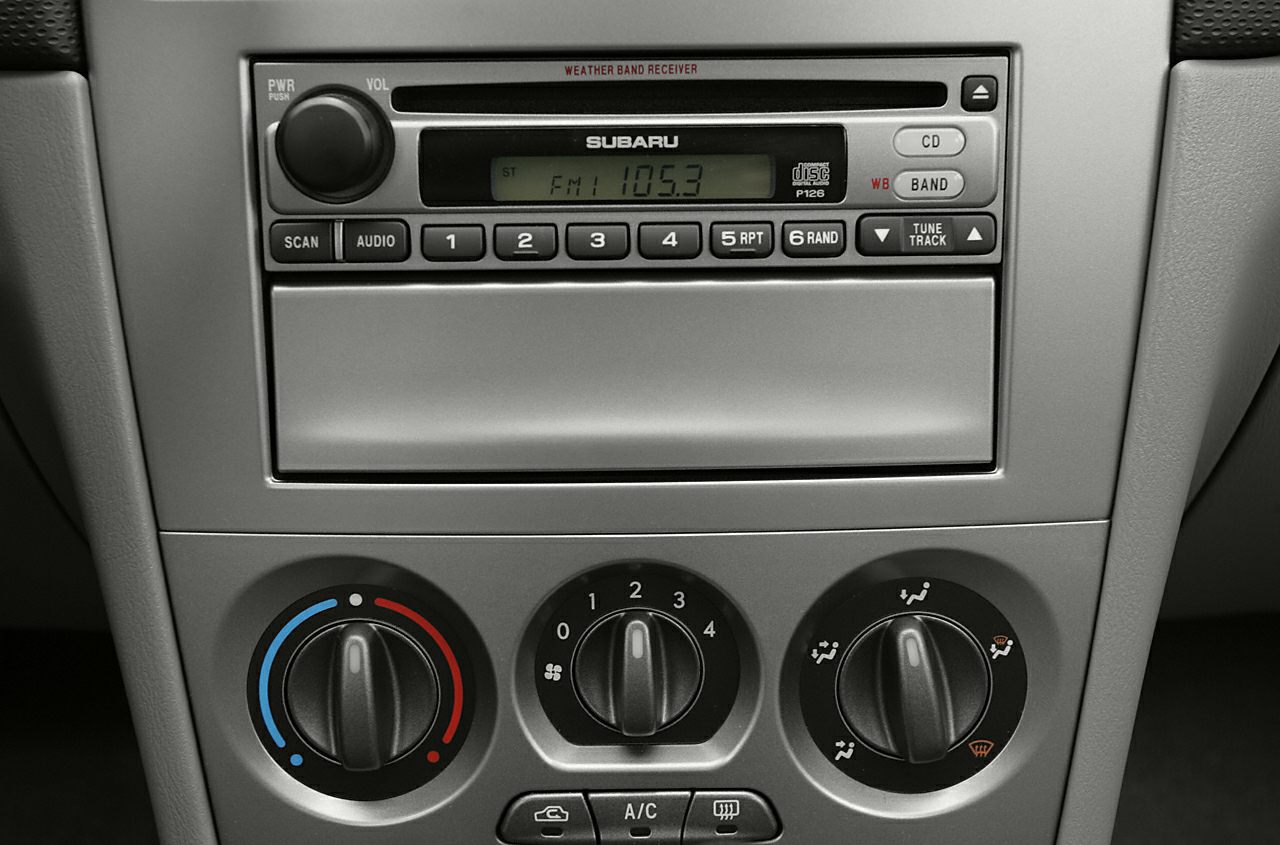 Car audio system and manual climate controls with dials and buttons