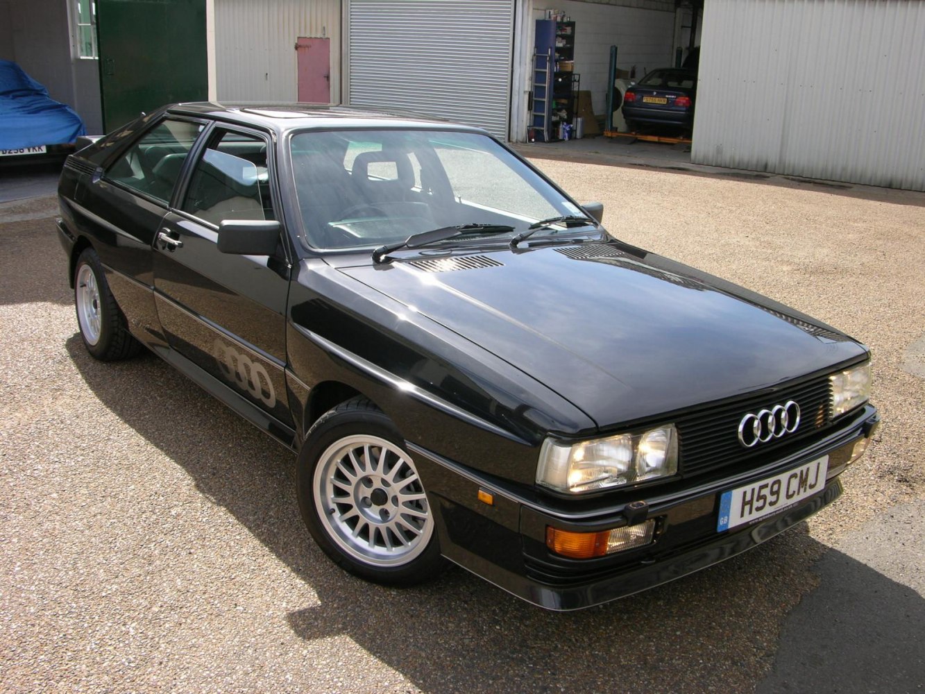 Sharp angular sport coupe front three-quarter view with alloy wheels