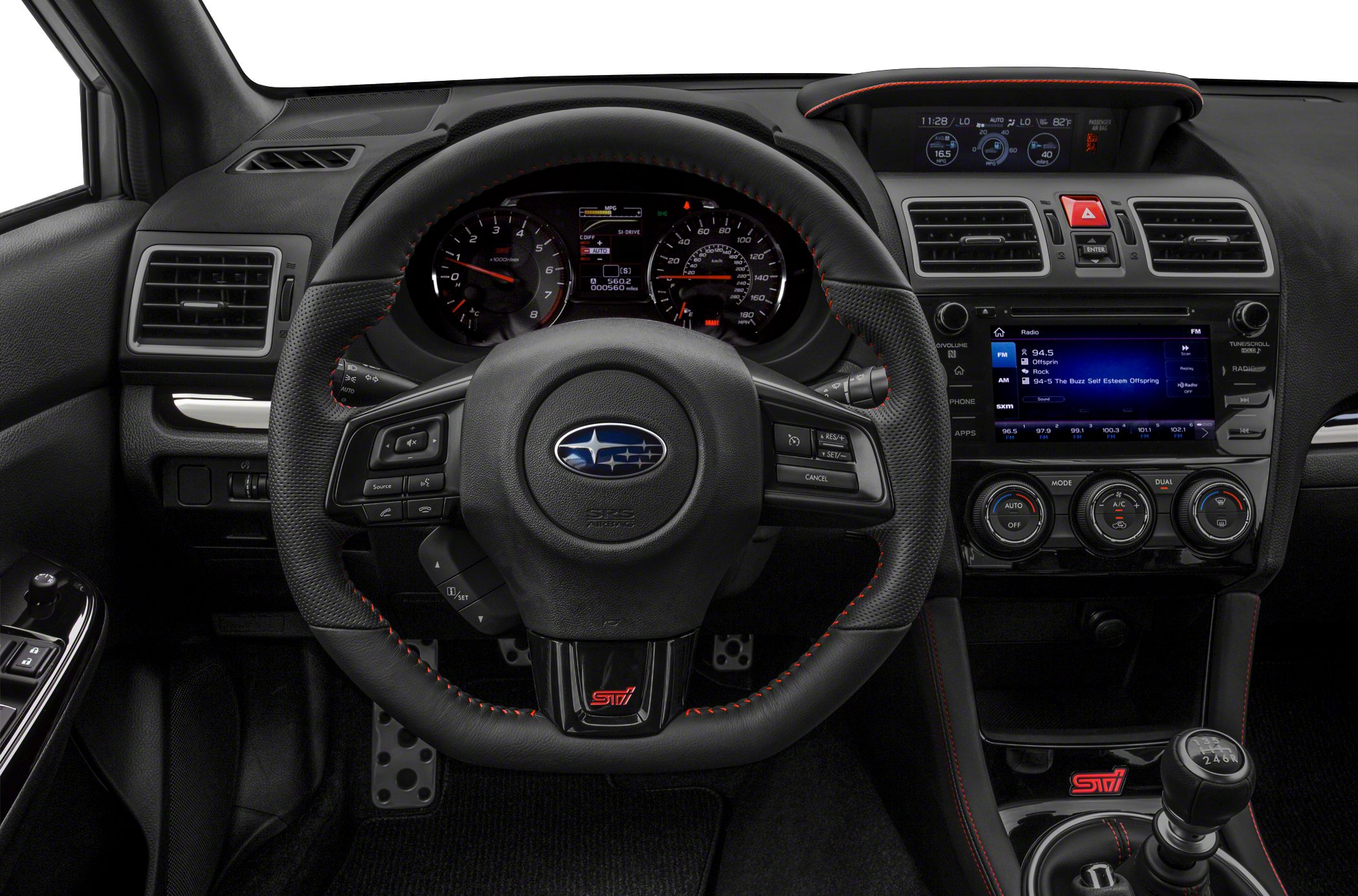 Dashboard and steering wheel with red stitching, manual gear shifter