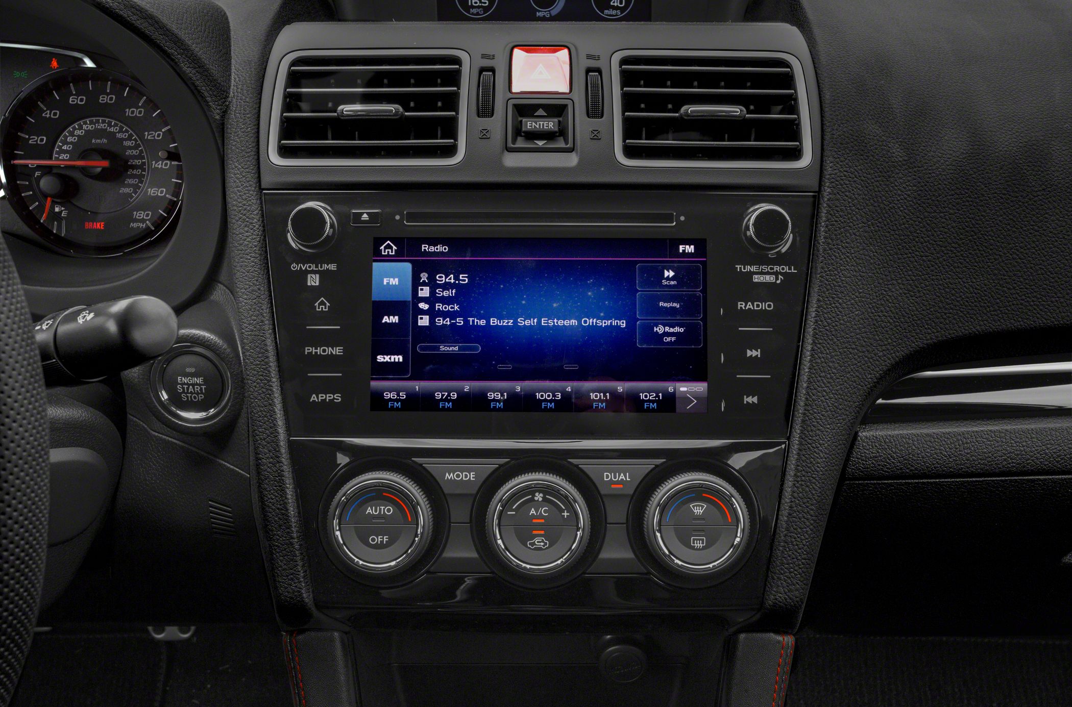 Infotainment touchscreen and climate control knobs on car dashboard