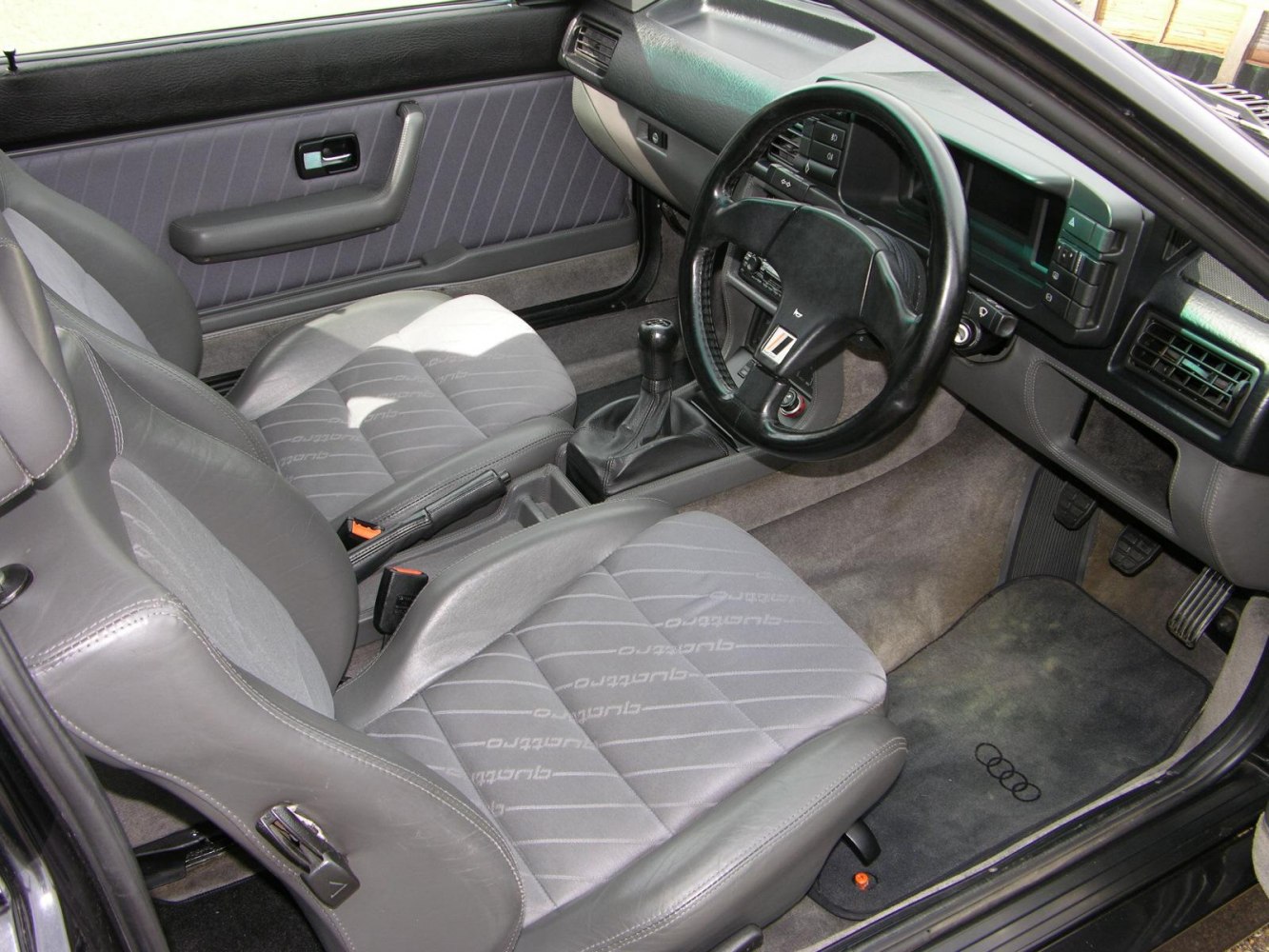 Manual transmission, sport seats, and classic dashboard design.