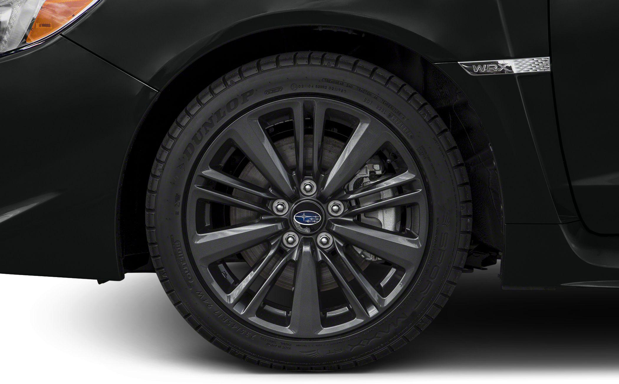Close-up of alloy wheel and WRX badge on sedan.