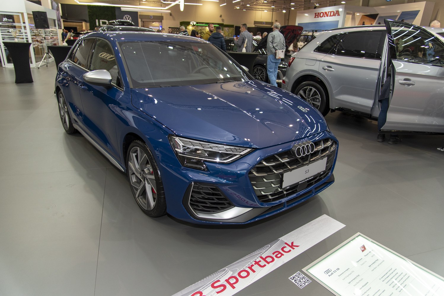 Aggressive front grille with LED headlights and blue hatchback body